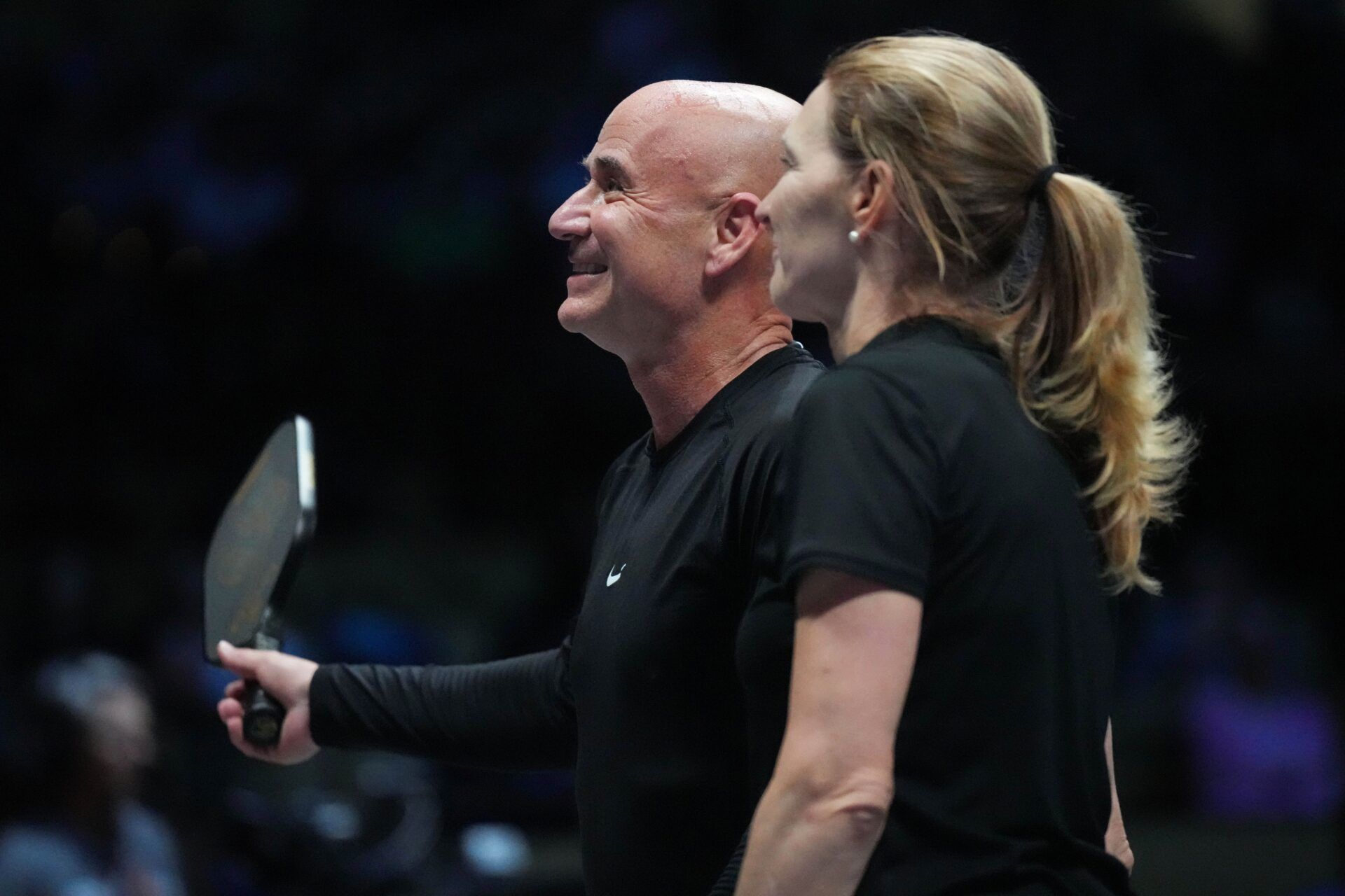 Andre Agassi and Steffi Graf acknowledge fans during Pickleball Slam 2 at Hard Rock Live at Seminole Hard Rock Hotel & Casino.