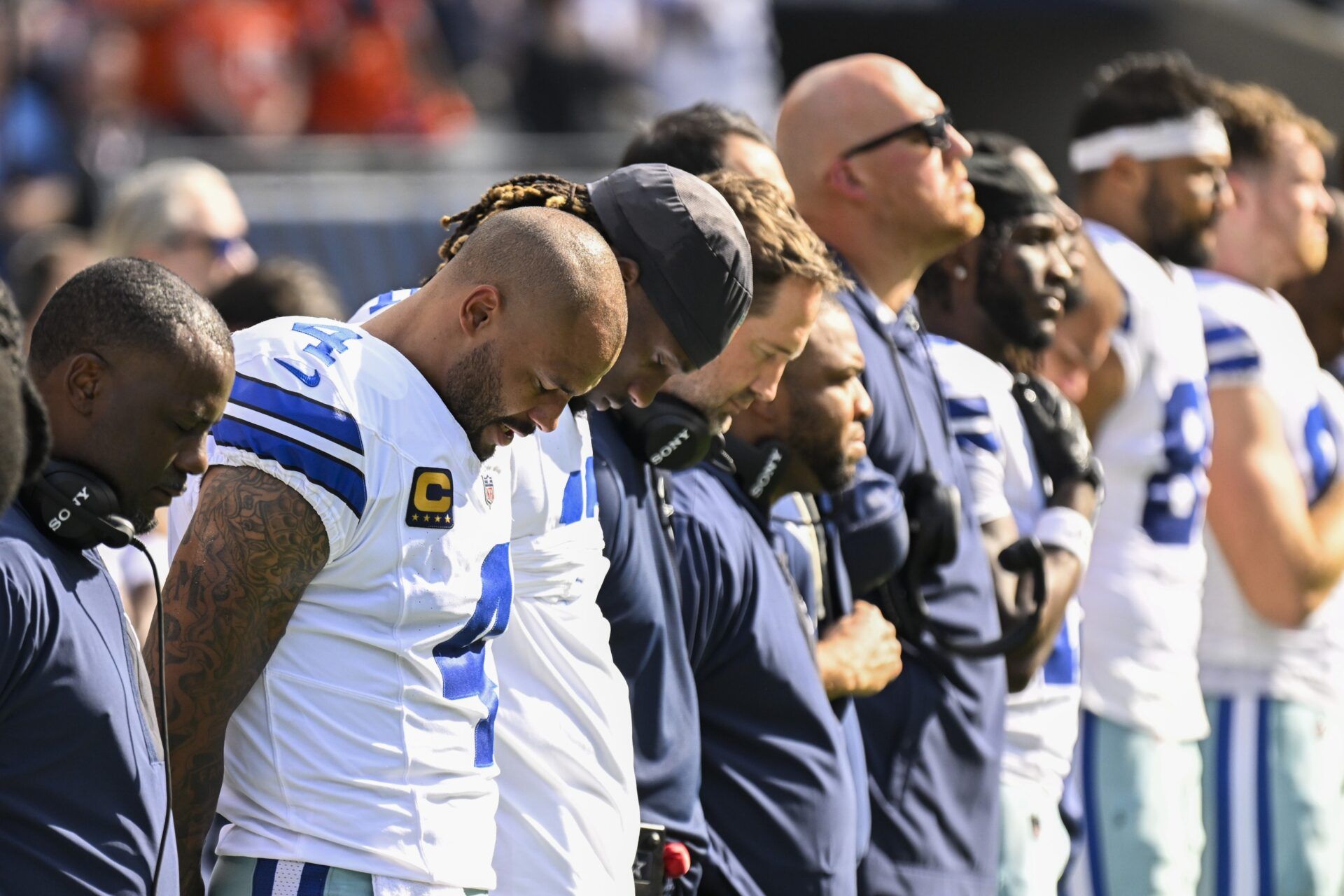 Dallas Cowboys quarterback Dak Prescott (4) , left,  during the National Anthem before the first half of their game against the Chicago Bears at Soldier Field.