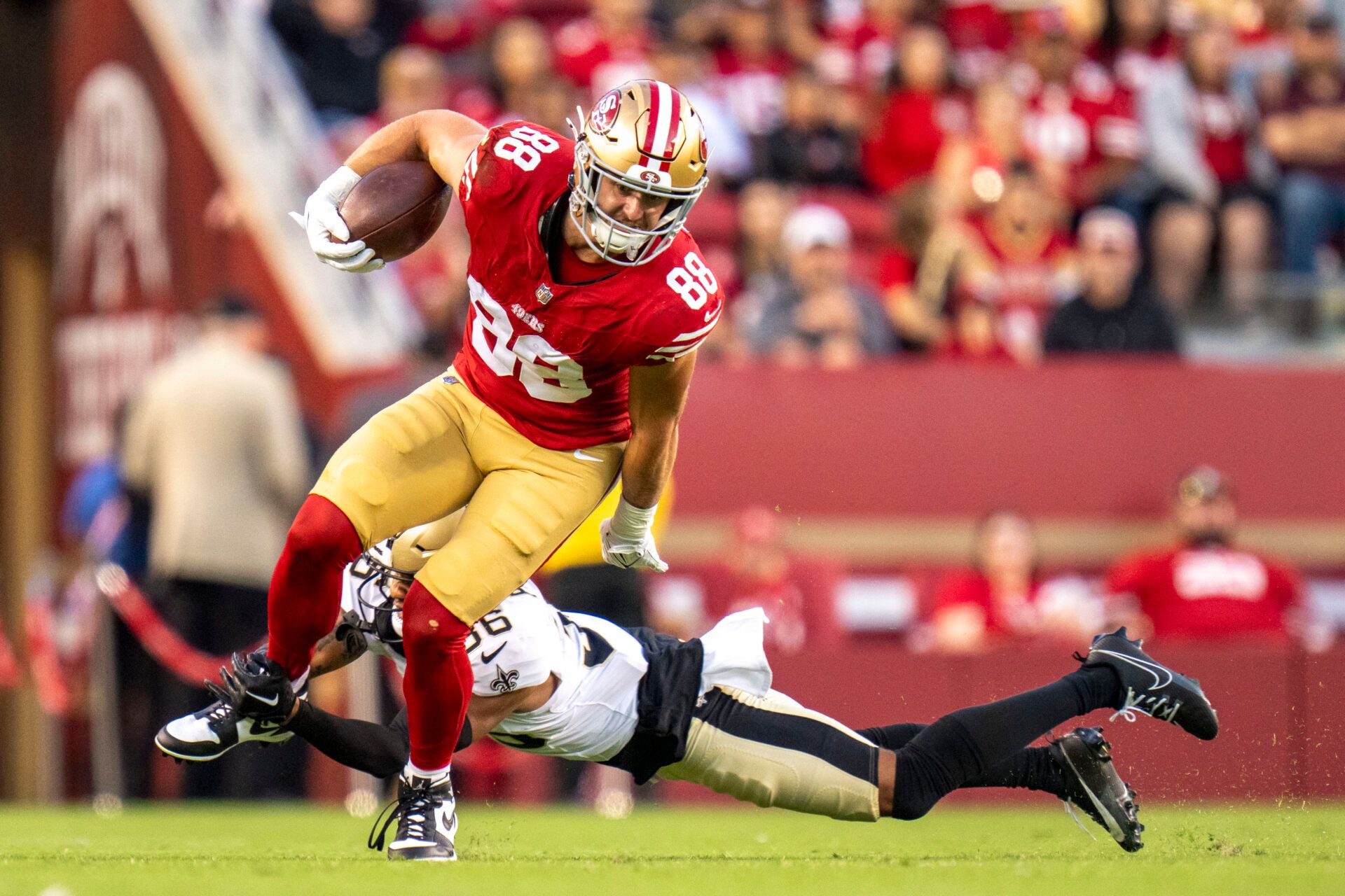 San Francisco 49ers tight end Jake Tonges (88) is tackled by New Orleans Saints cornerback Rico Payton (36) during the fourth quarter at Levi's Stadium.