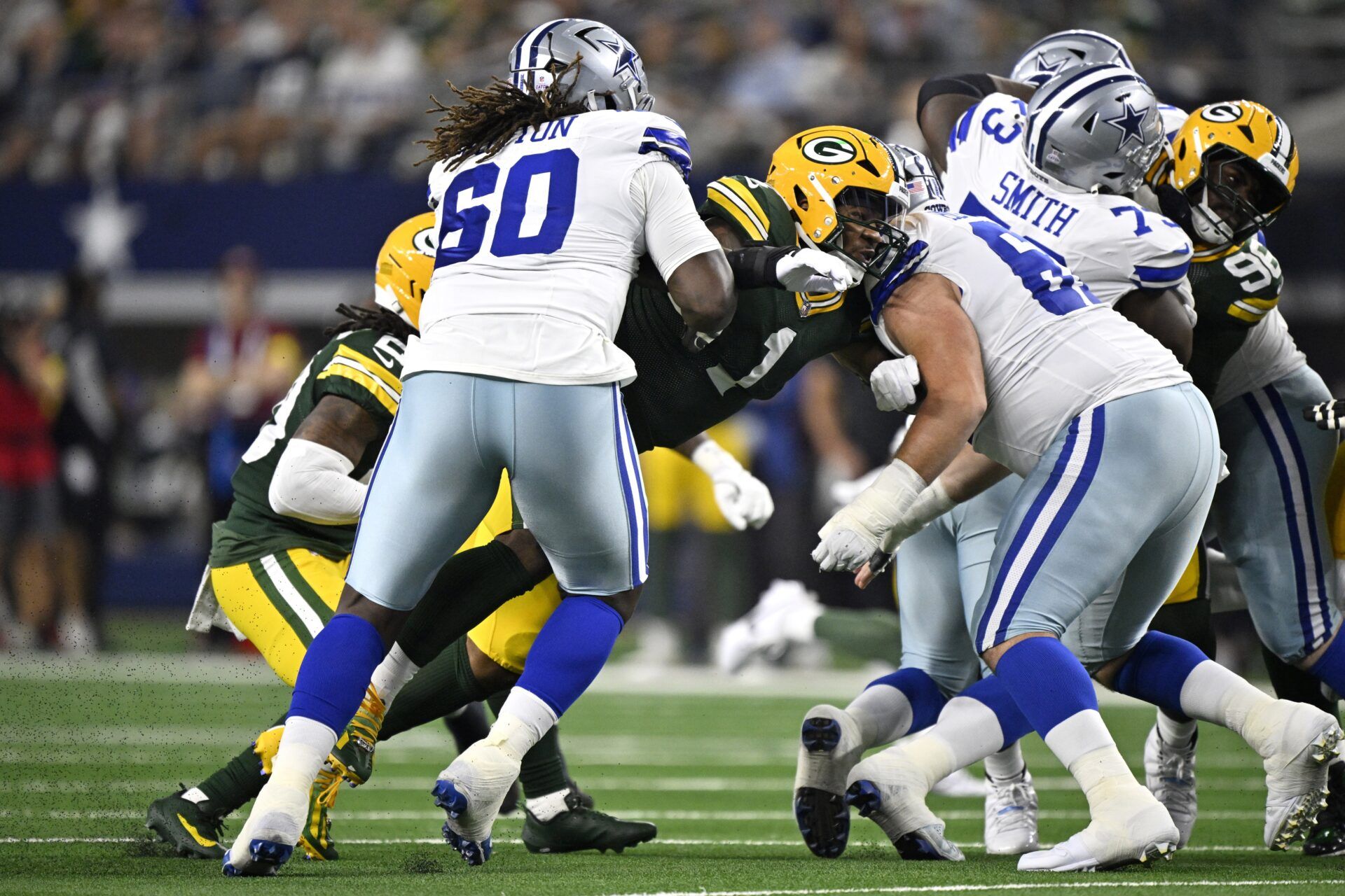 Dallas Cowboys offensive tackle Tyler Guyton (60) and center Brock Hoffman (67) defend against Green Bay Packers defensive end Micah Parsons (1) in the first quarter at AT&T Stadium.