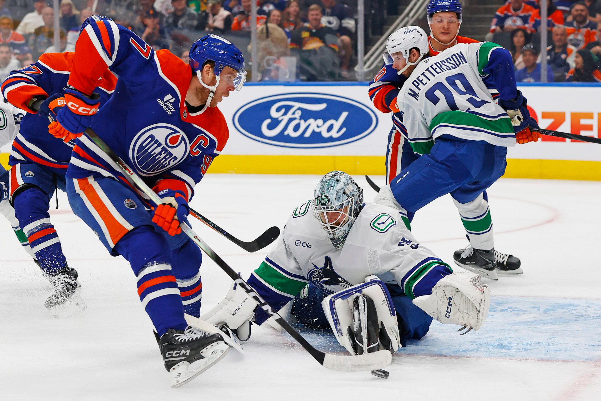 Vancouver Canucks goaltender Thatcher Demko (35) makes a save on  on Edmonton Oilers forward Connor McDavid (97) during the first period at Rogers Place.