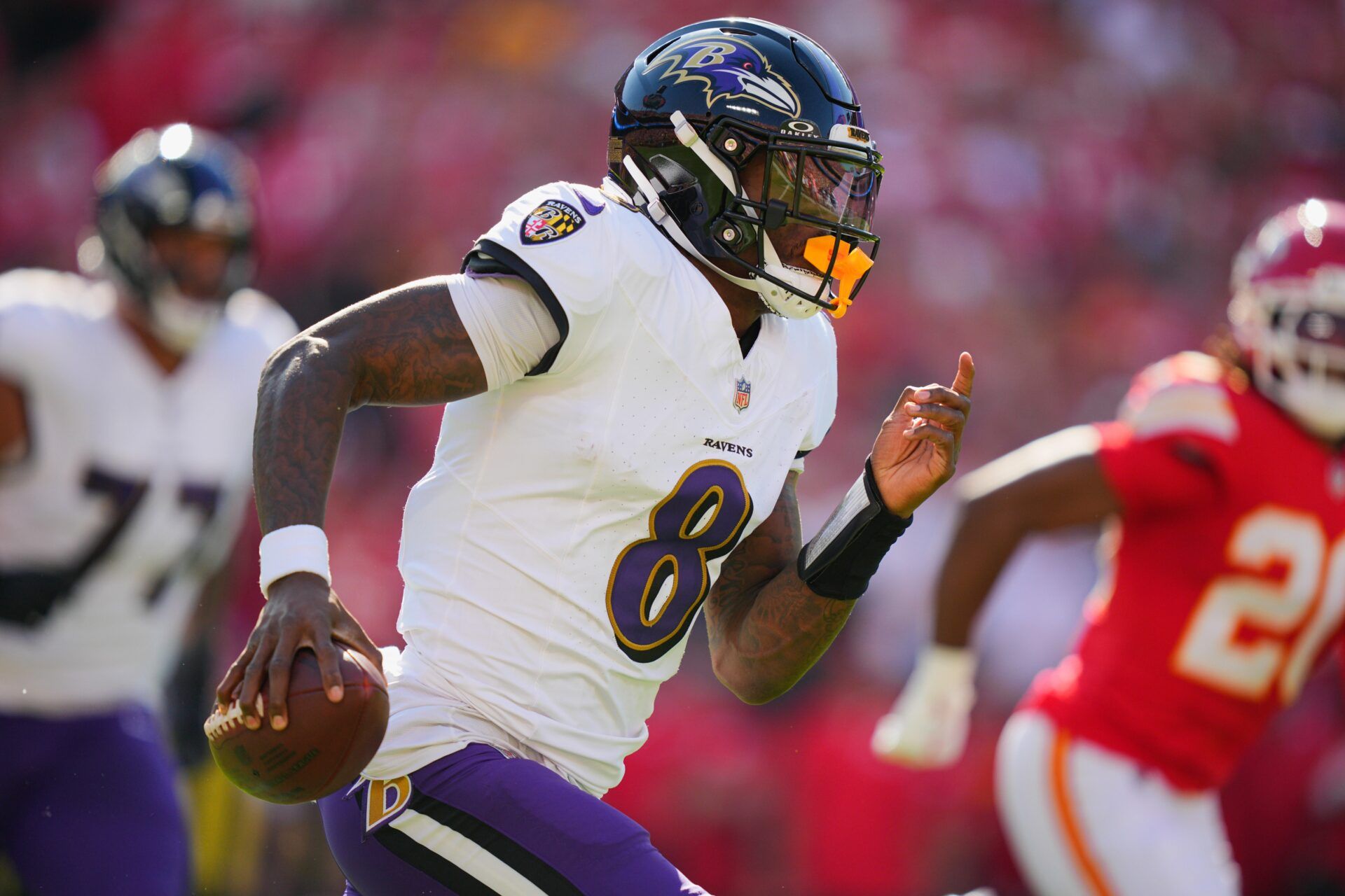 Baltimore Ravens quarterback Lamar Jackson (8) scrambles during the first half against the Kansas City Chiefs at GEHA Field at Arrowhead Stadium.