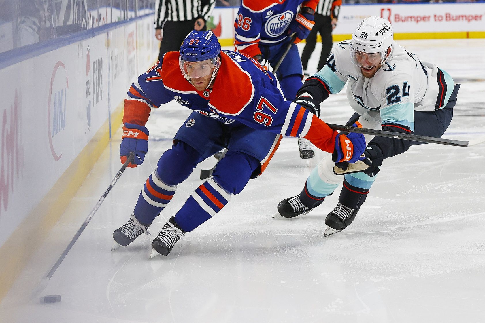 Edmonton Oilers forward Connor McDavid (97) carries the puck around Seattle Kraken defensemen Jamie Oleksiak (24) during the third period at Rogers Place.