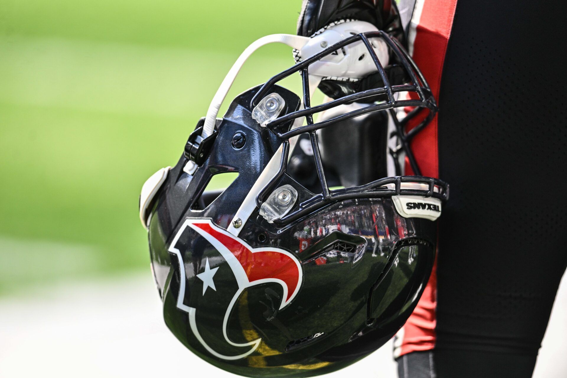A Houston Texans player holds onto his helmet from the sideline during the game against the Minnesota Vikings at U.S. Bank Stadium.