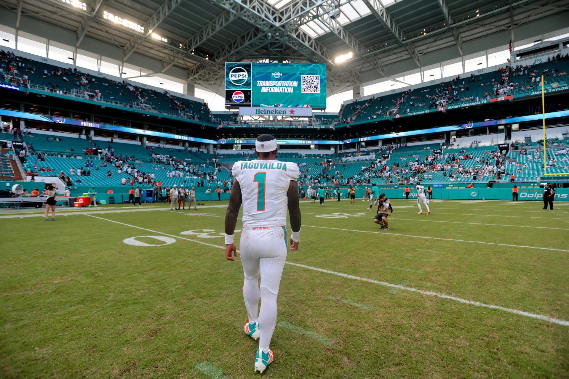 Miami Dolphins quarterback Tua Tagovailoa (1) walks off the field after the game against the New England Patriots at Hard Rock Stadium.