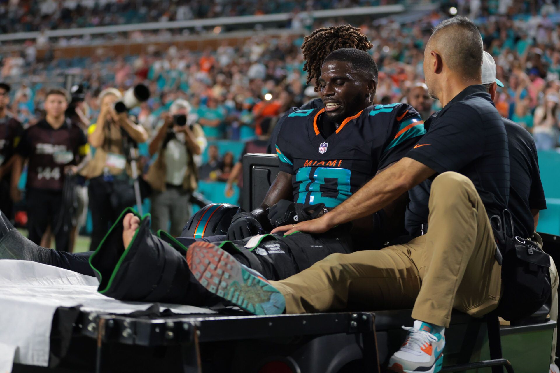 Miami Dolphins wide receiver Tyreek Hill (10) reacts after being placed on a medical cart against the New York Jets during the second half at Hard Rock Stadium.