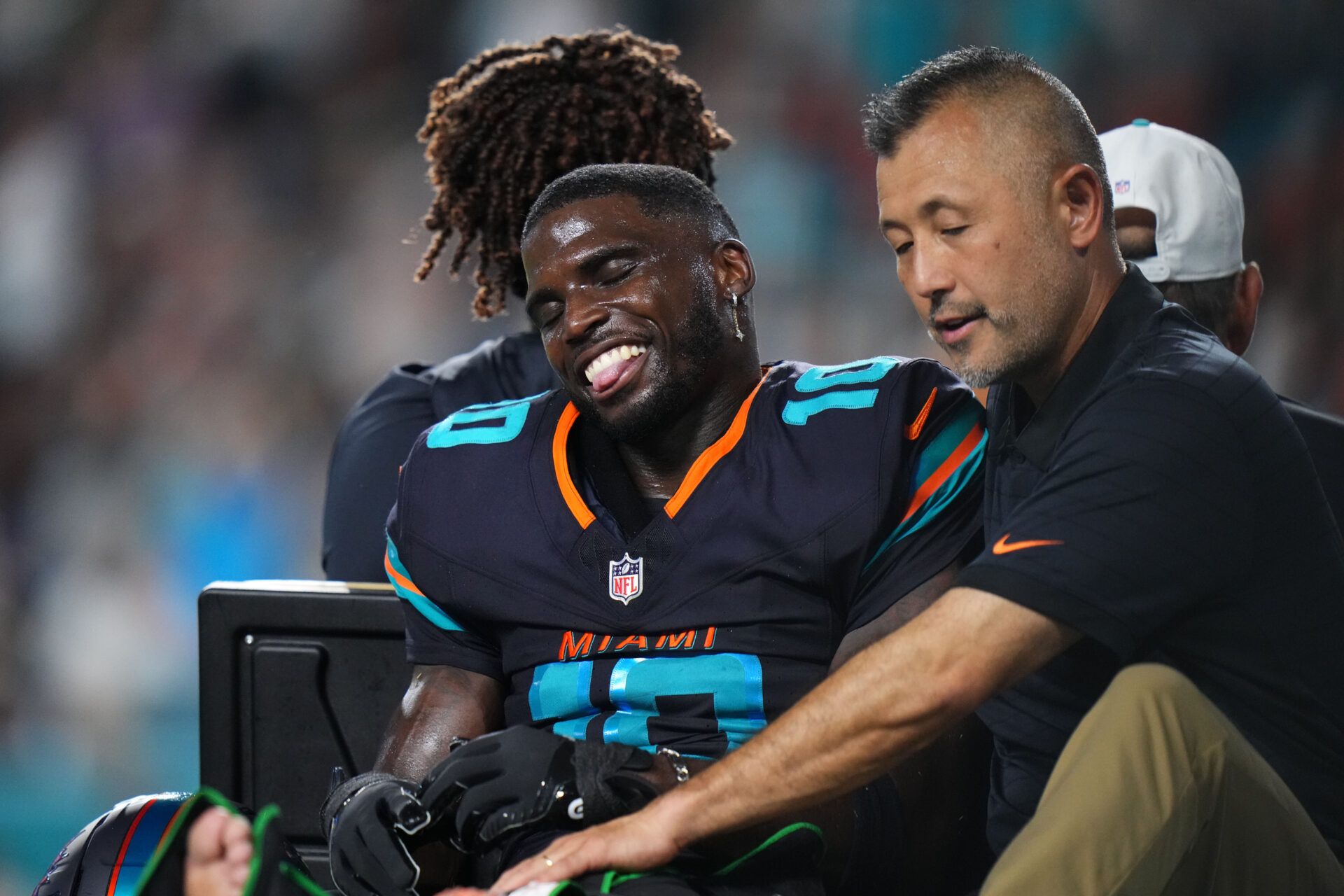 Miami Dolphins wide receiver Tyreek Hill (10) is tended to by medical staff after injuring his leg against the New York Jets during the second half at Hard Rock Stadium.
