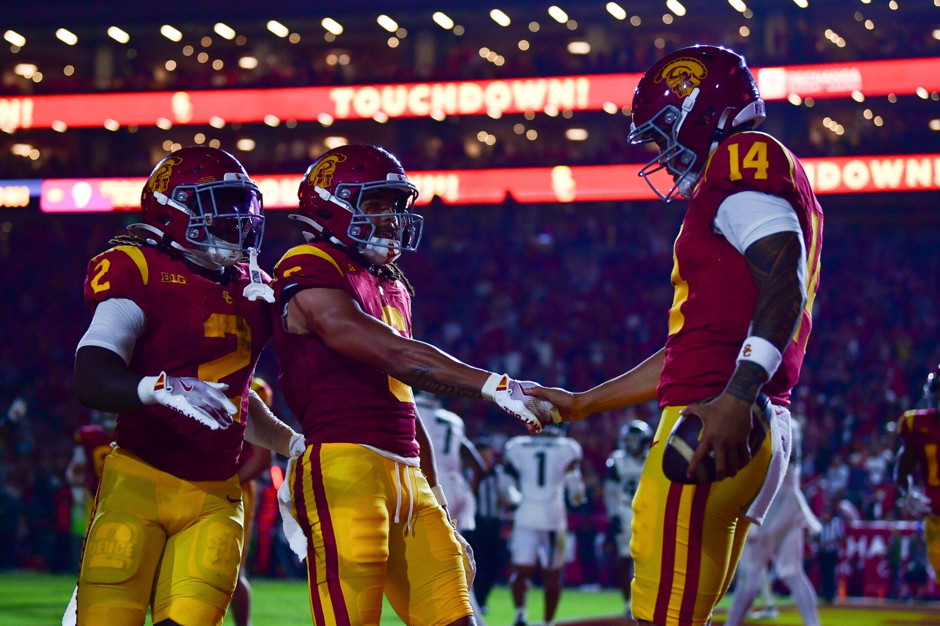 Southern California Trojans quarterback Jayden Maiava (14) celebrates his touchdown scored against the Michigan State Spartans with wide receiver Makai Lemon (6) and running back Waymond Jordan (2) during the first half at the Los Angeles Memorial Coliseum.