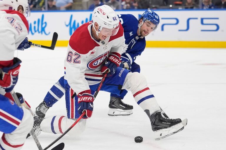 Montreal Canadiens forward Owen Beck (62)  tries to get control of the puck against the Toronto Maple Leafs during the third period at Scotiabank Arena.