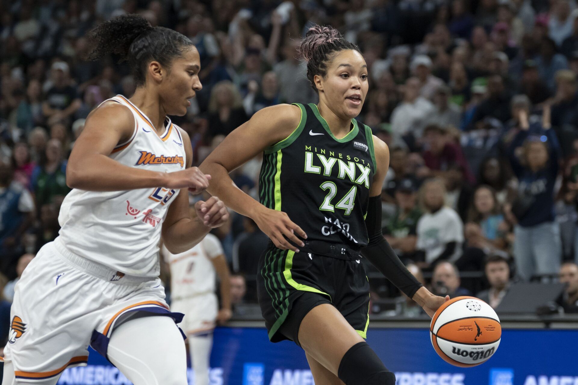Minnesota Lynx forward Napheesa Collier (24) dribbles past Phoenix Mercury forward Alyssa Thomas (25) in the first half during game two of the second round for the 2025 WNBA Playoffs at Target Center.