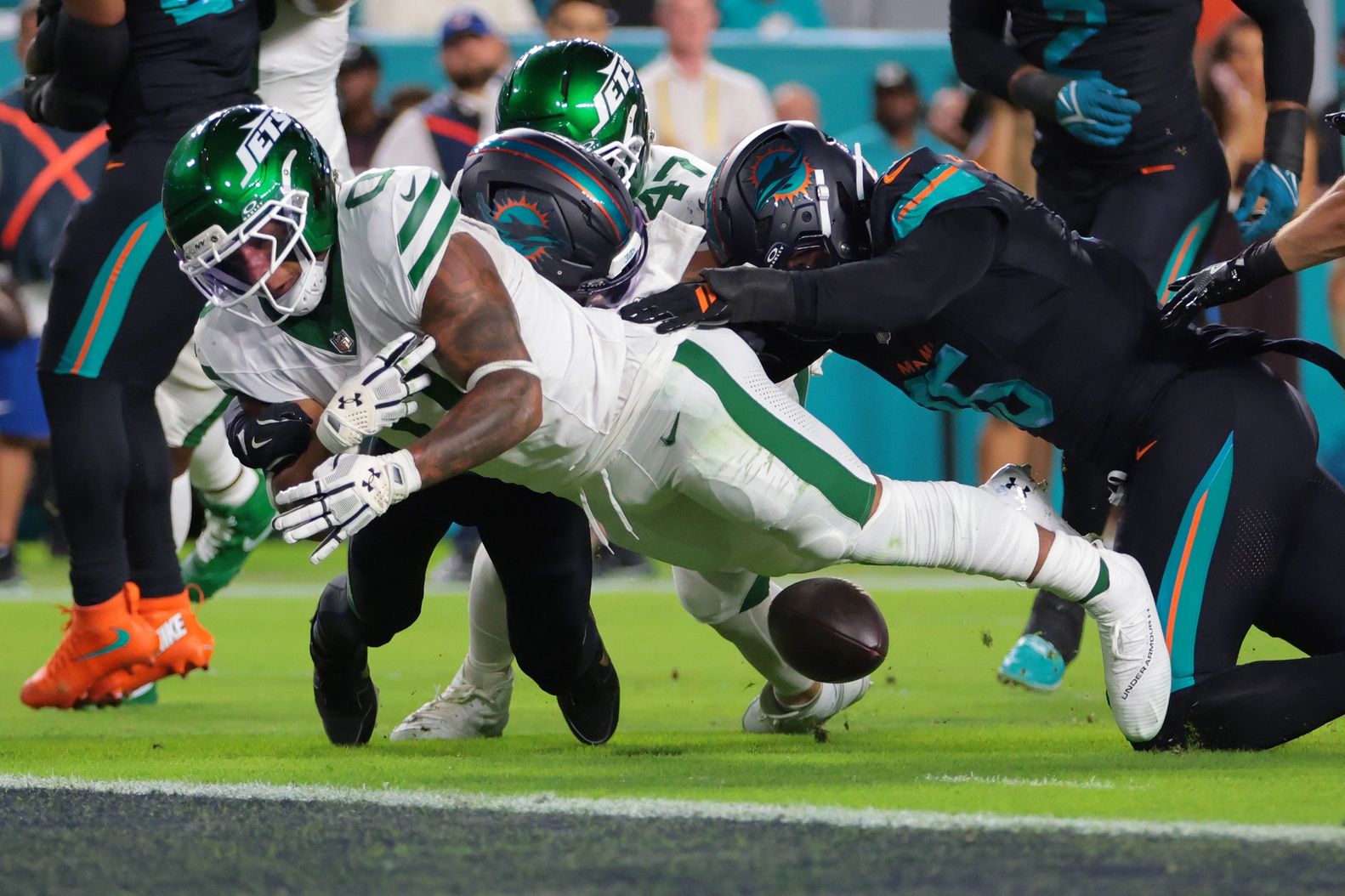 New York Jets running back Braelon Allen (0) fumbles the ball against Miami Dolphins defensive back Elijah Campbell (22) during the first half at Hard Rock Stadium.