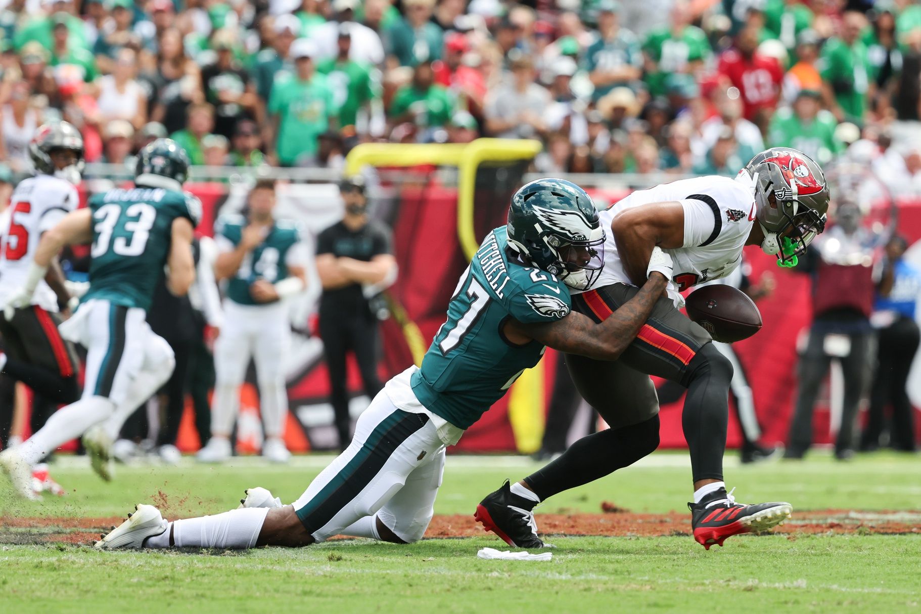 Philadelphia Eagles cornerback Quinyon Mitchell (27) tackles Tampa Bay Buccaneers wide receiver Emeka Egbuka (2) during the first quarter at Raymond James Stadium.