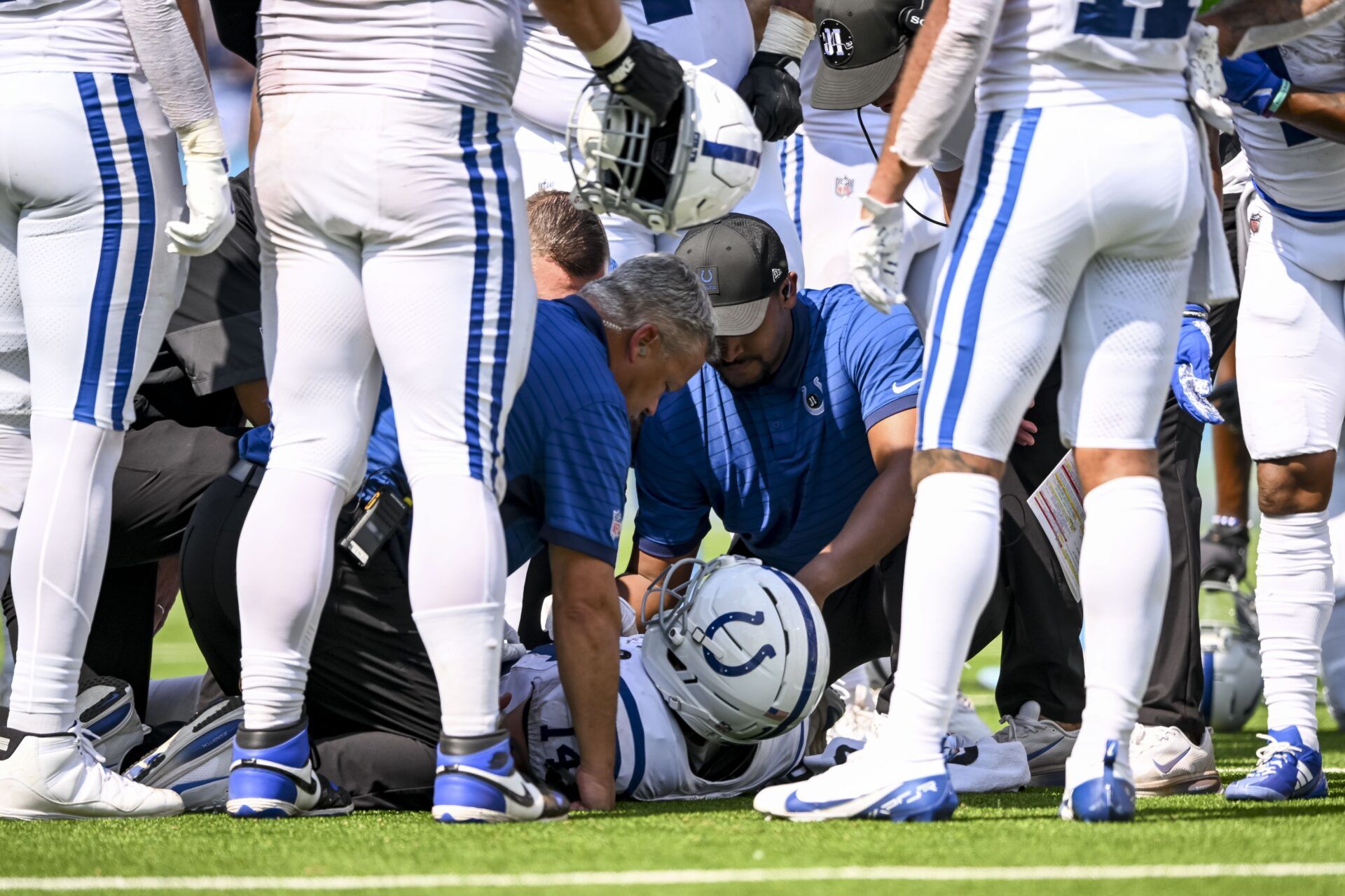 Indianapolis Colts trainers look at Indianapolis Colts wide receiver Alec Pierce (14) during the fourth quarter at Nissan Stadium.