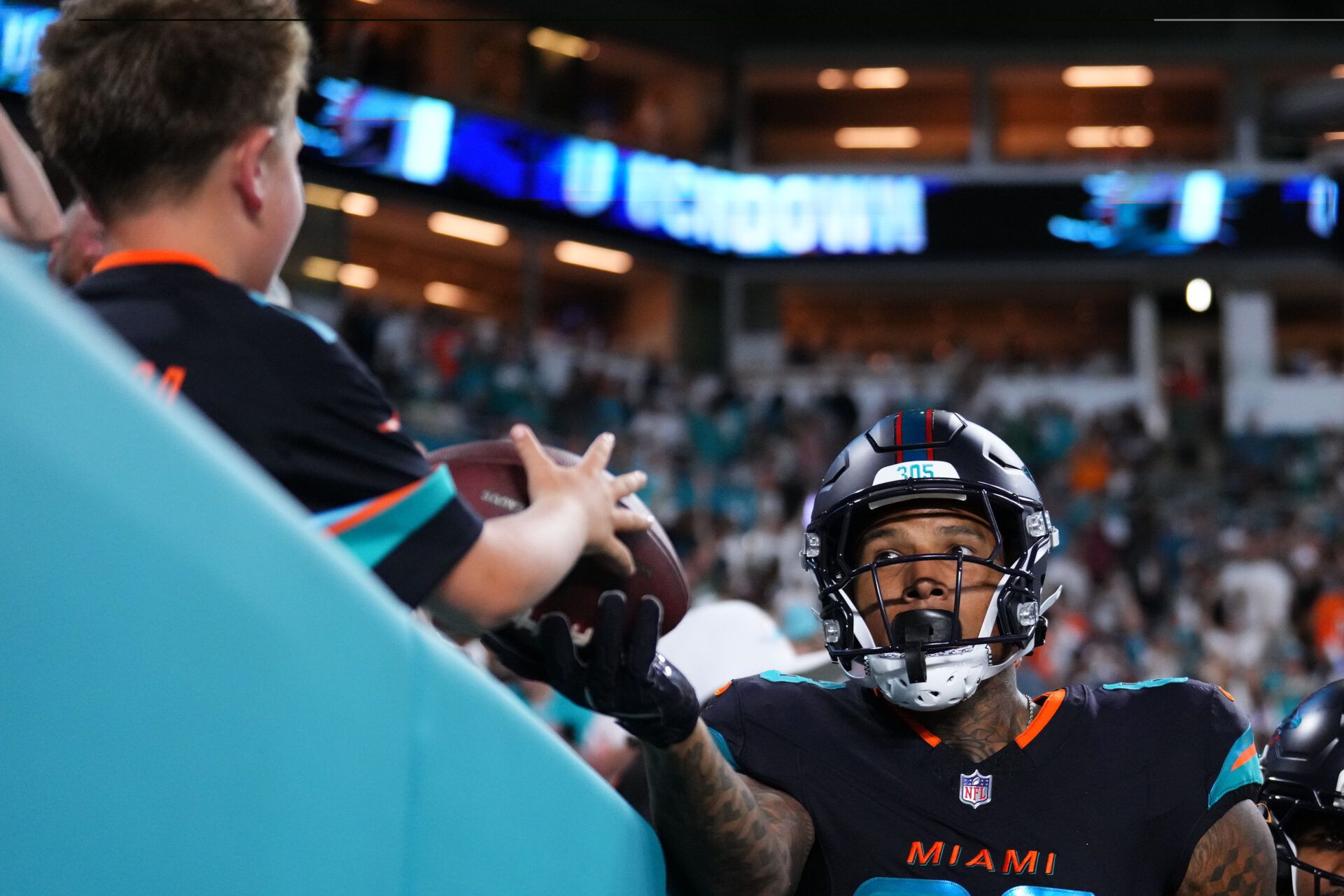 Miami Dolphins tight end Darren Waller (83) gives the ball to a fan after scoring a touchdown against the New York Jets during the second half at Hard Rock Stadium.