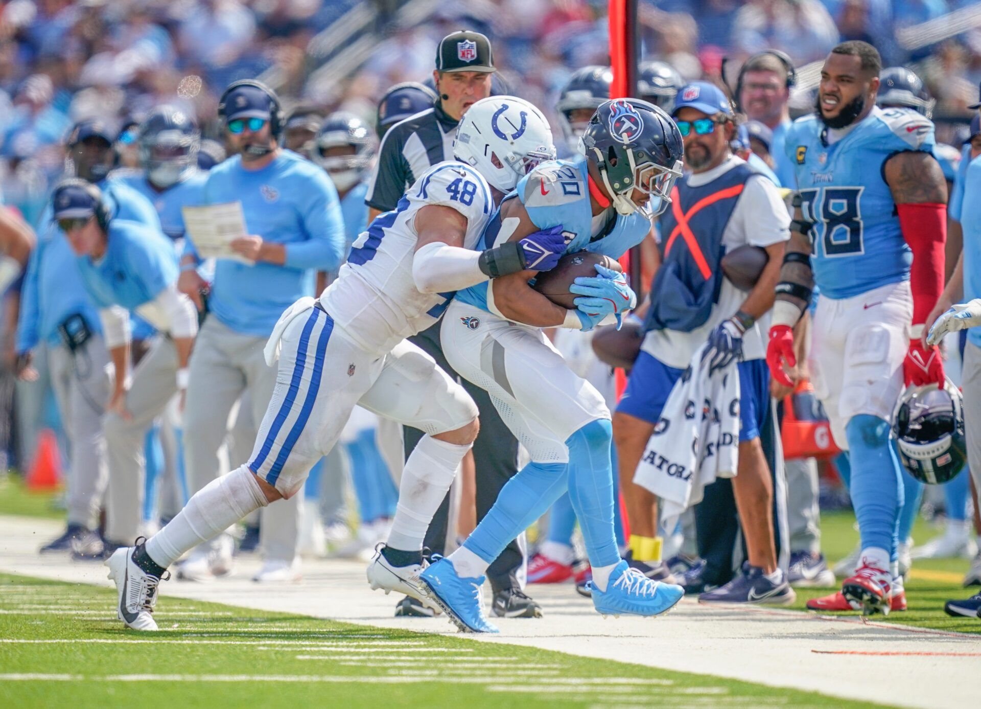 Tennessee Titans running back Tony Pollard (20) is pushed out of bounds by Indianapolis Colts linebacker Joe Bachie (48) during the third quarter at Nissan Stadium in Nashville, Tenn., Sunday, Sept. 21, 2025.