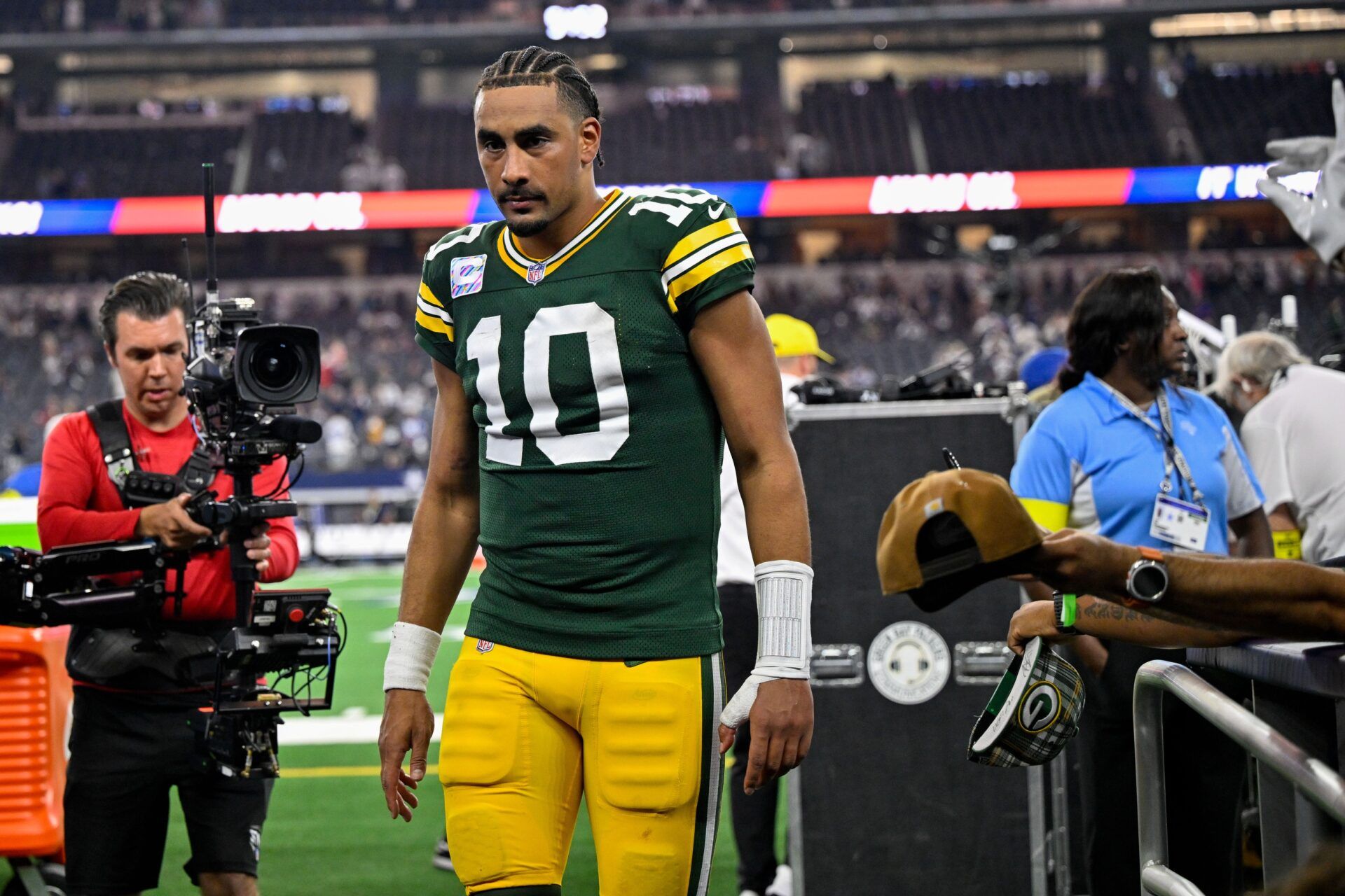 Green Bay Packers quarterback Jordan Love (10) walks off the field after the game between the Dallas Cowboys and the Green Bay Packers at AT&T Stadium.