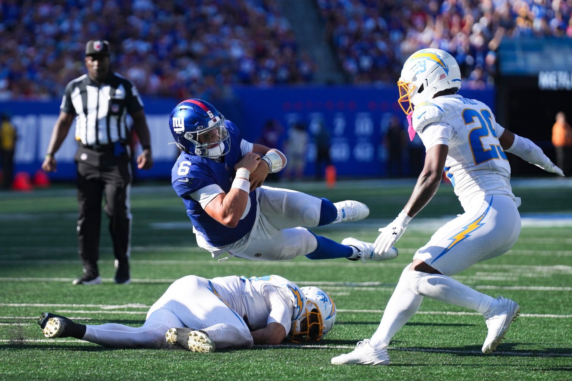 New York Giants quarterback Jaxson Dart (6) falls during a game against the Los Angeles Chargers at MetLife Stadium, Sep 28, 2025, East Rutherford, NJ, USA.