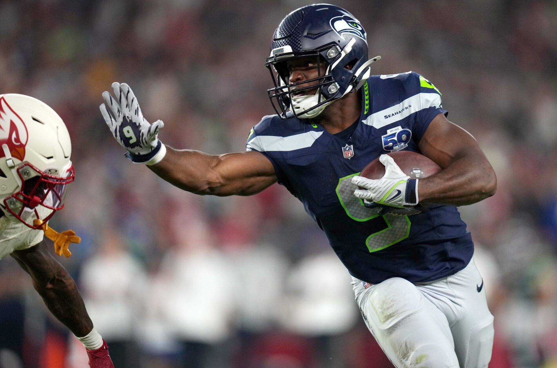 Seattle Seahawks running back Kenneth Walker III (9) attempts to stiff arm Arizona Cardinals cornerback Kei'Trel Clark (13) at State Farm Stadium in Glendale on Sept. 25, 2025.