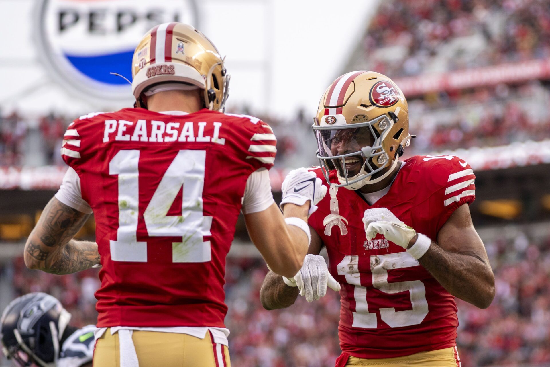 San Francisco 49ers wide receiver Jauan Jennings (15) celebrates with wide receiver Ricky Pearsall (14) against the Seattle Seahawks during the fourth quarter at Levi's Stadium.