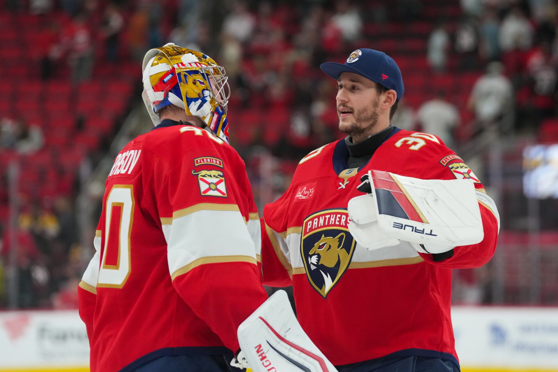 Florida Panthers goaltender Daniil Tarasov (40) and goaltender Brandon Bussi (30) celebrate their victory against the Carolina Hurricanes at Lenovo Center.