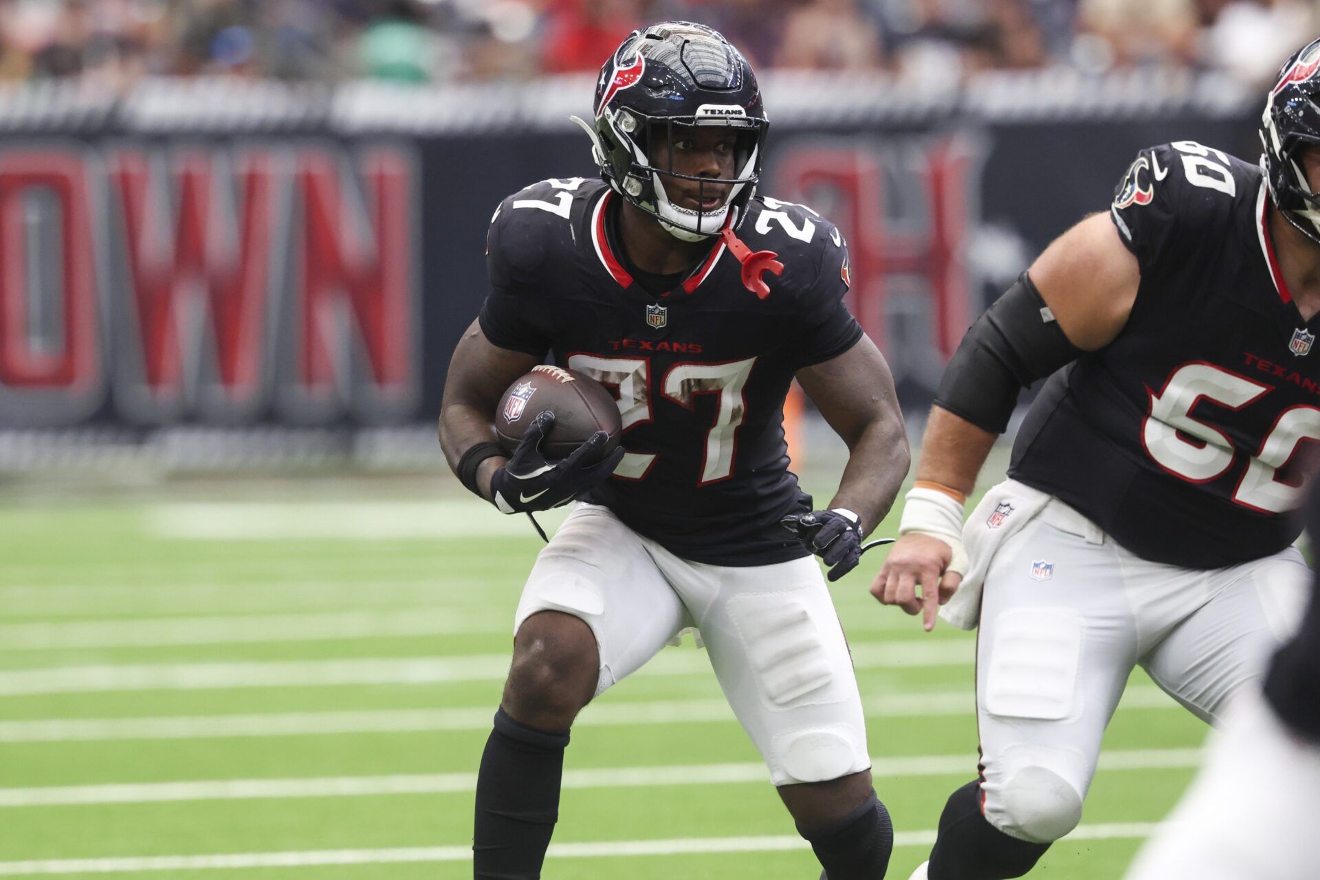 Houston Texans running back Woody Marks (27) runs with the ball during the fourth quarter against the Tennessee Titans at NRG Stadium.
