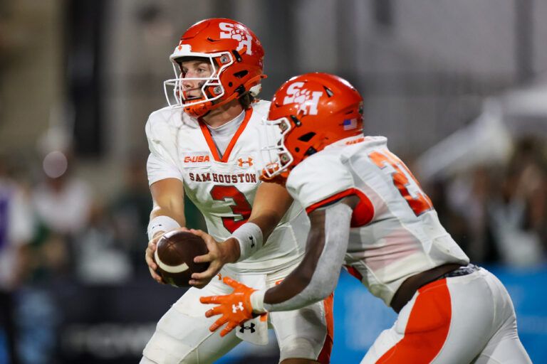 Sam Houston Bearkats quarterback Mabrey Mettauer (3) hands off the ball to running back Elijah Green (21) against Hawaii Rainbow Warriors during the second quarter at Clarence T.C. Ching Athletics Complex.