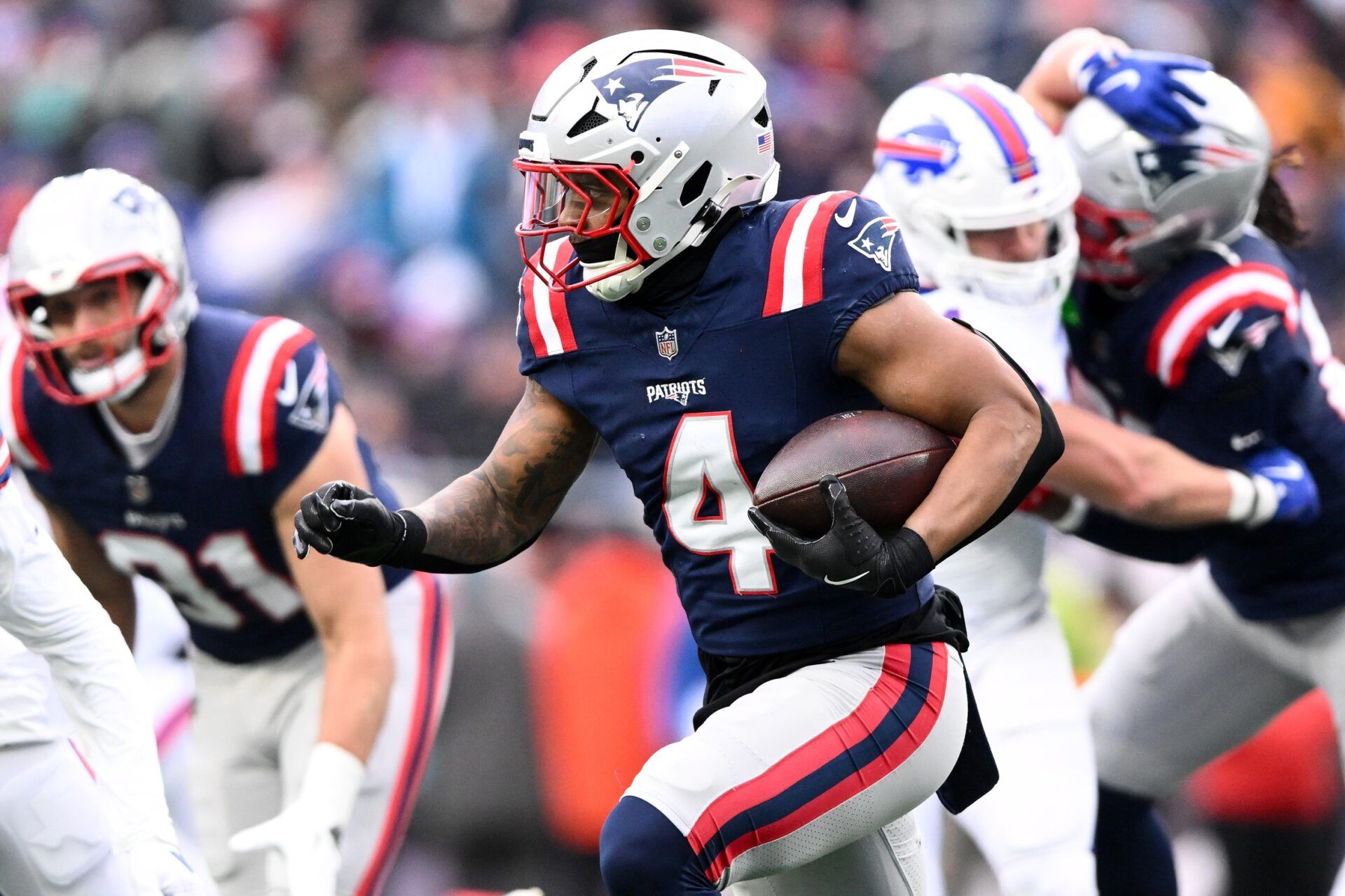 New England Patriots running back Antonio Gibson (4) runs against the Buffalo Bills during the first half at Gillette Stadium.
