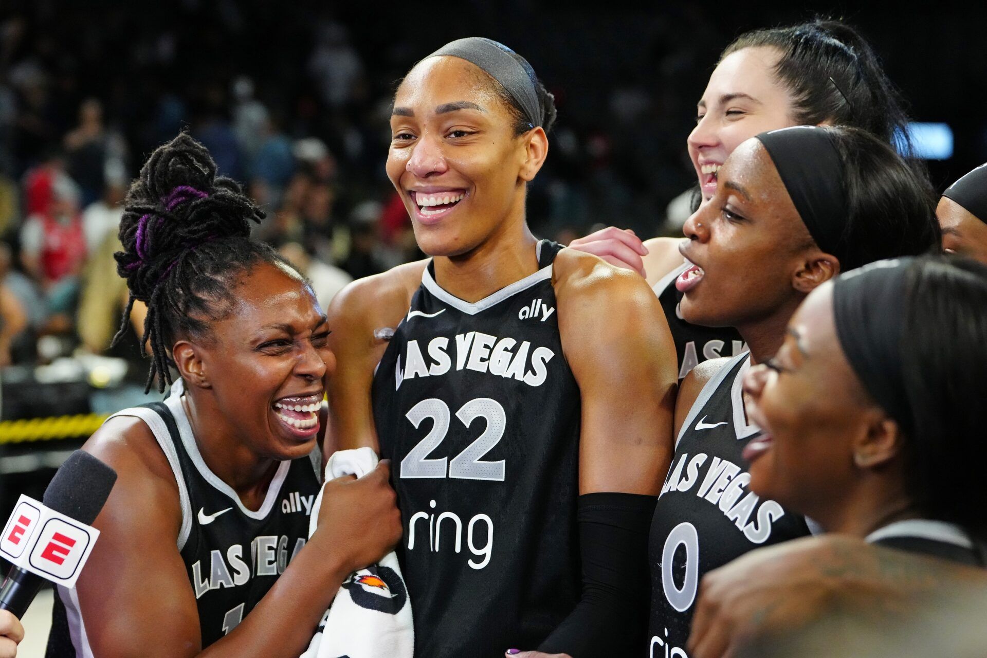 Las Vegas Aces guard Chelsea Gray (12), Las Vegas Aces center A'ja Wilson (22), and Las Vegas Aces guard Jackie Young (0) react during an interview after defeating the Indiana Fever 107-98 in overtime of game five of the second round for the 2025 WNBA Playoffs at Michelob Ultra Arena.