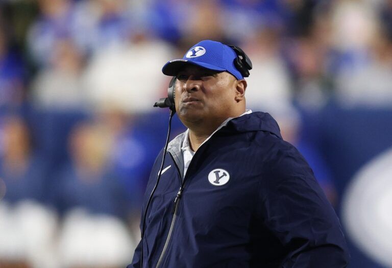 Brigham Young Cougars head coach Kalani Sitake checks the clock during the second quarter of the game against the West Virginia Mountaineers at LaVell Edwards Stadium.