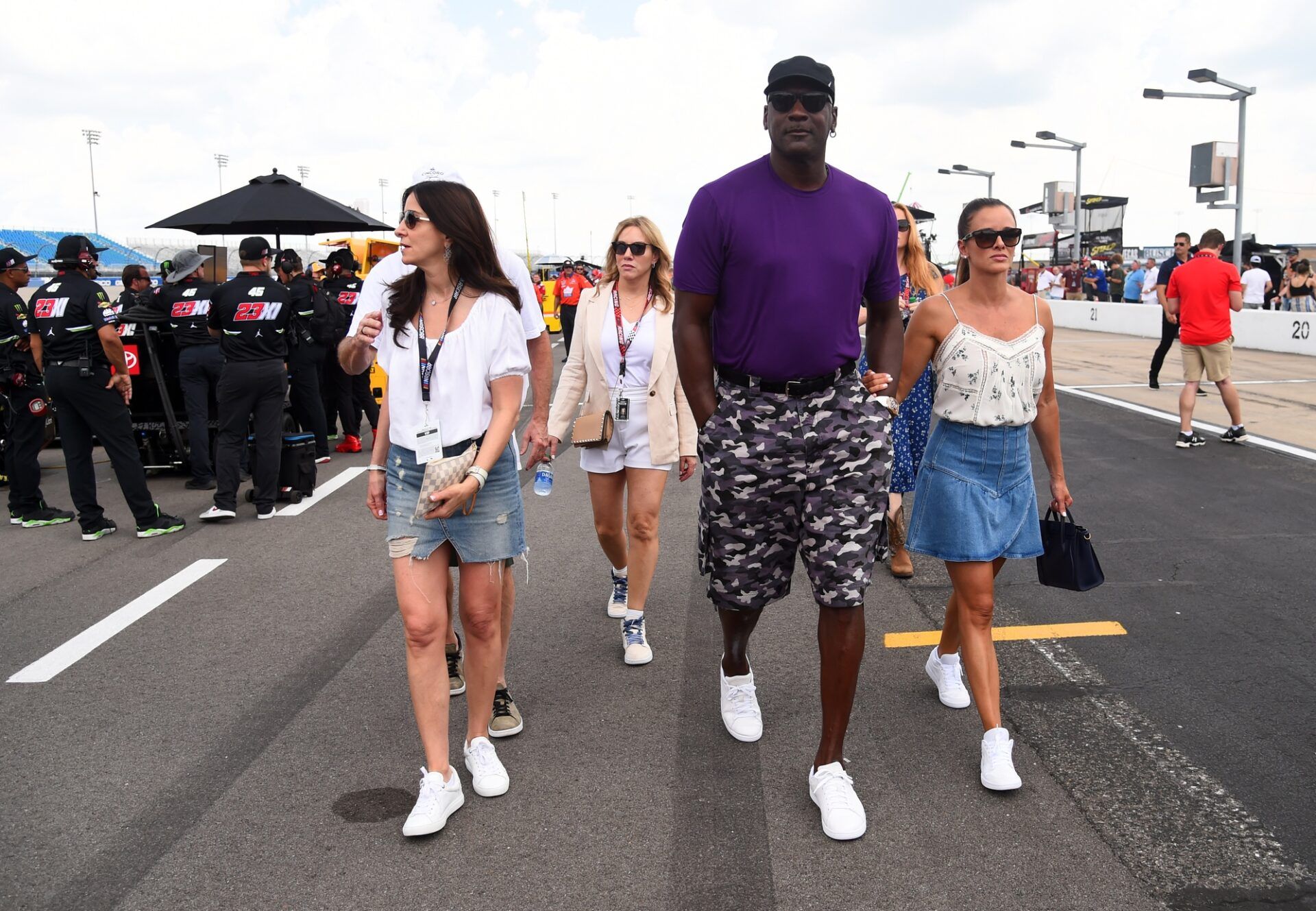 NASCAR Cup Series 23XI Racing owner Michael Jordan walks pit road with his wife Yvette Prieto during qualifying for the Ally 400 at Nashville Superspeedway.