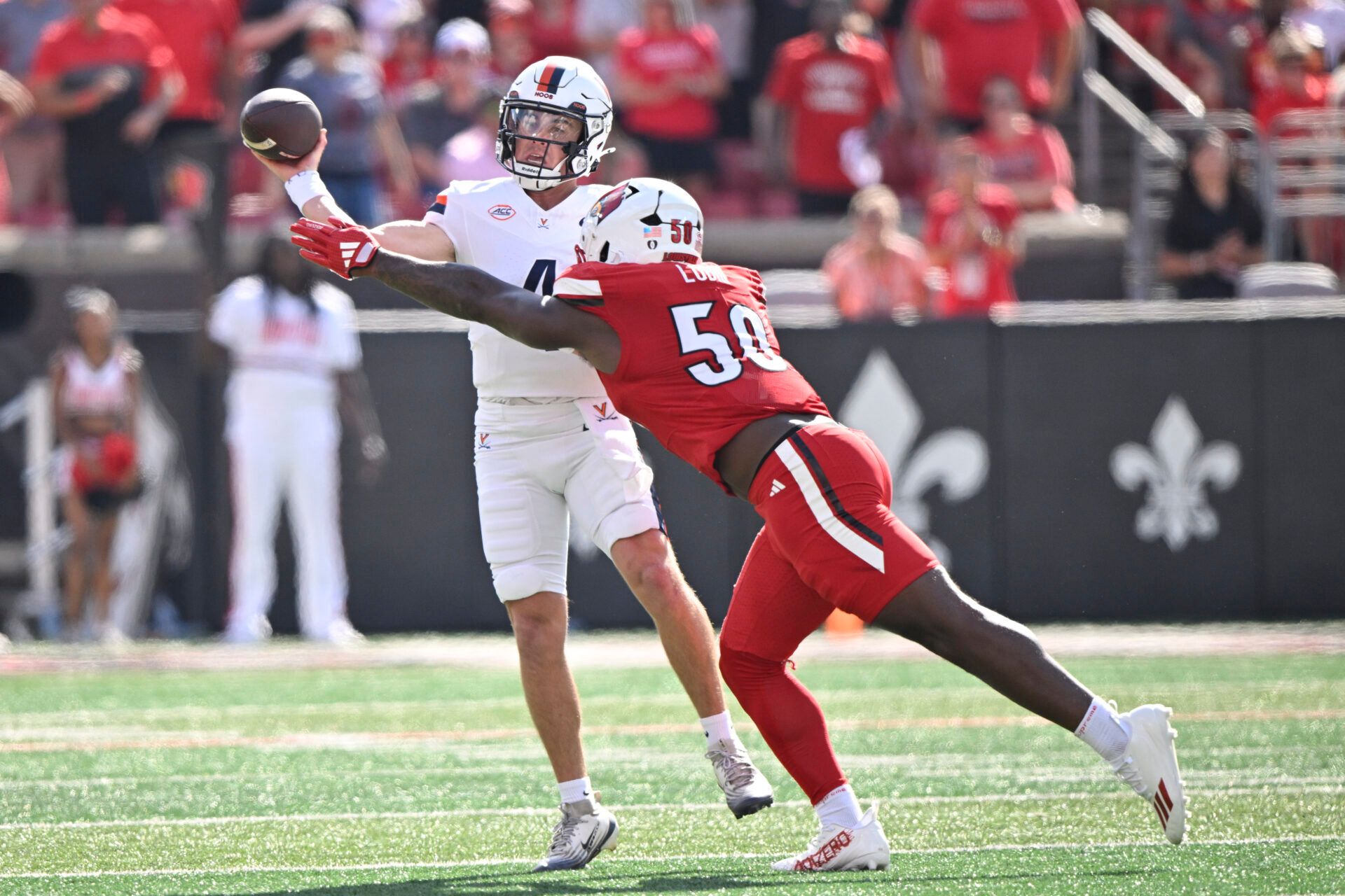 Virginia Cavaliers quarterback Chandler Morris (4) looks to pass against Louisville Cardinals defensive lineman Clev Lubin (50) during the first quarter at L&N Federal Credit Union Stadium.