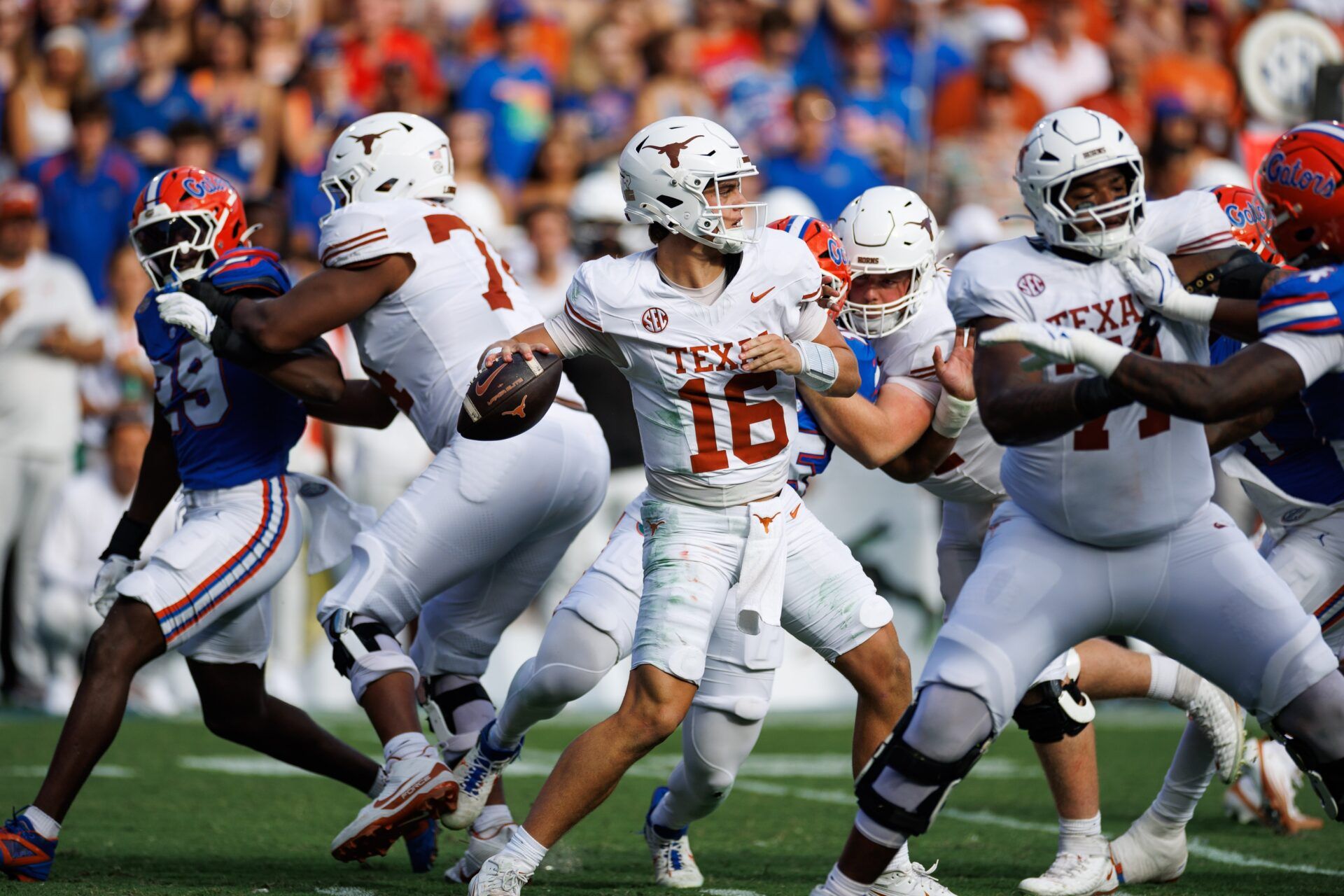 Texas Longhorns quarterback Arch Manning (16) throws the ball in the pocket against the Florida Gators during the first half at Ben Hill Griffin Stadium.