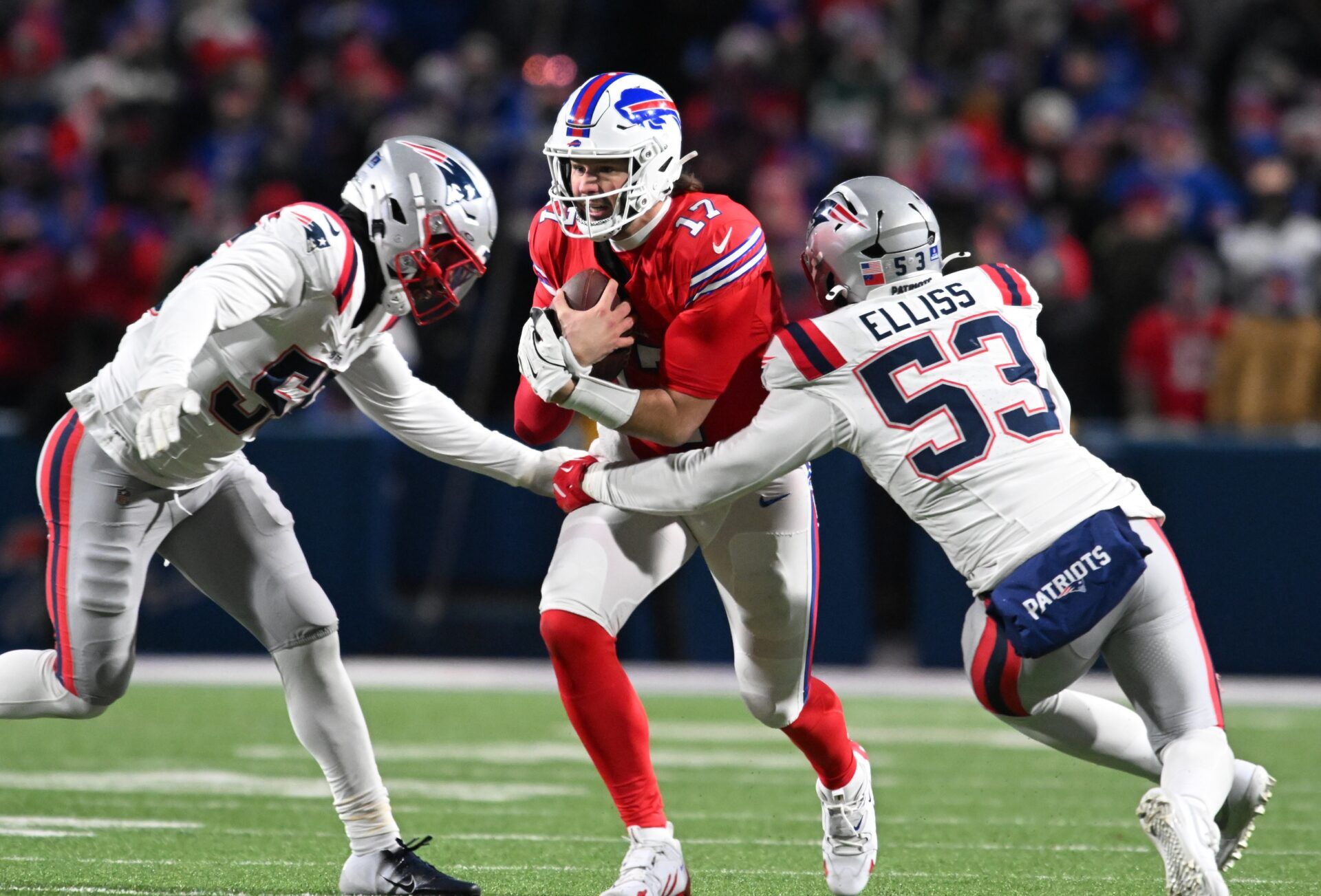Buffalo Bills quarterback Josh Allen (17) is tackled by New England Patriots linebacker Yannick Ngakoue (55) and linebacker Christian Elliss (53) in the fourth quarter at Highmark Stadium.
