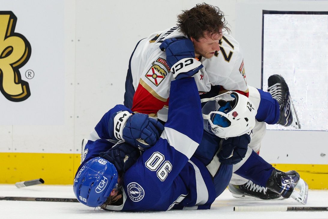 Florida Panthers center Eetu Luostarinen (27) pushes Tampa Bay Lightning defenseman J.J. Moser (90) down to the ice in the third period at Benchmark International Arena.