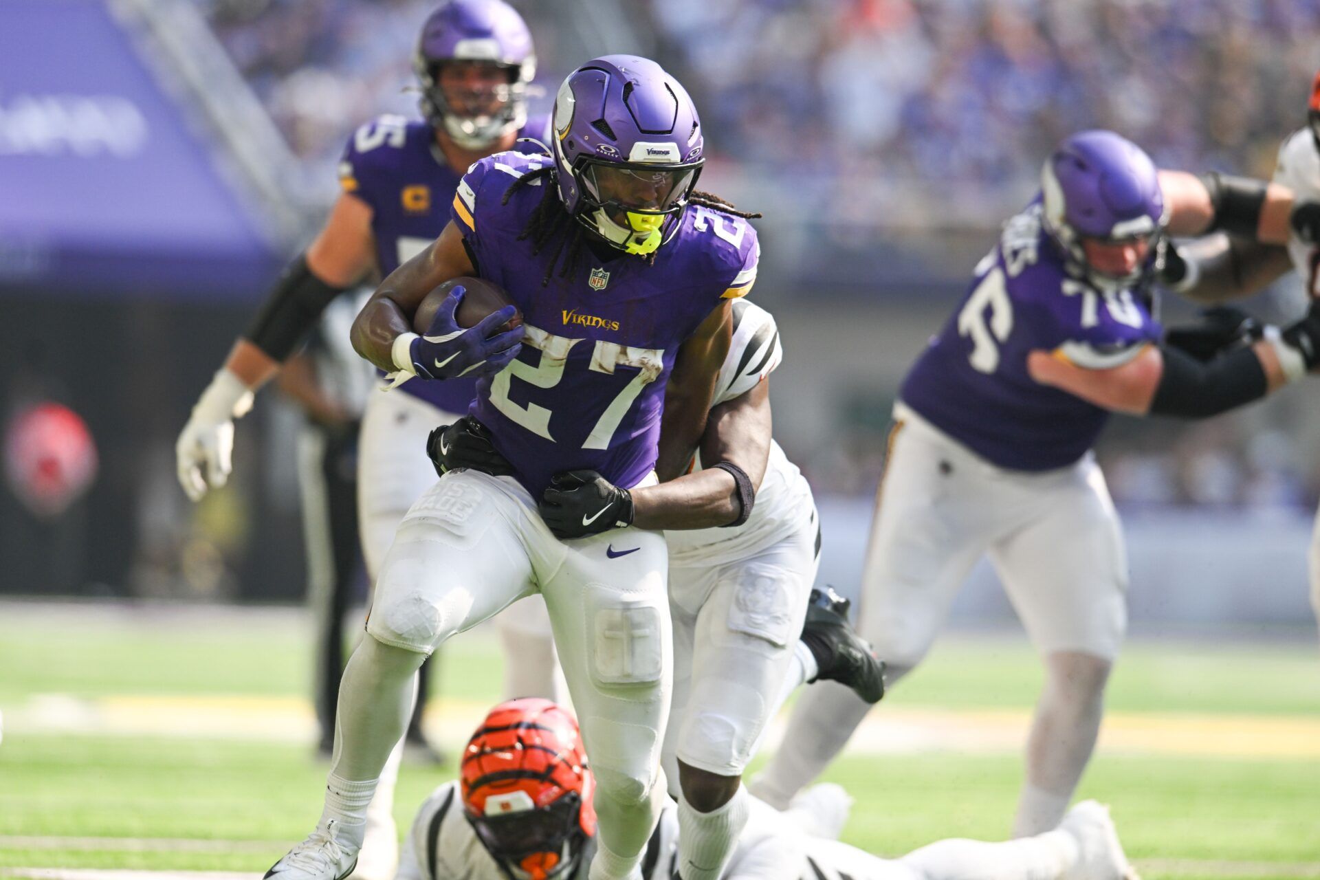 Minnesota Vikings running back Jordan Mason (27) carries the ball against the Cincinnati Bengals during the second half at U.S. Bank Stadium.