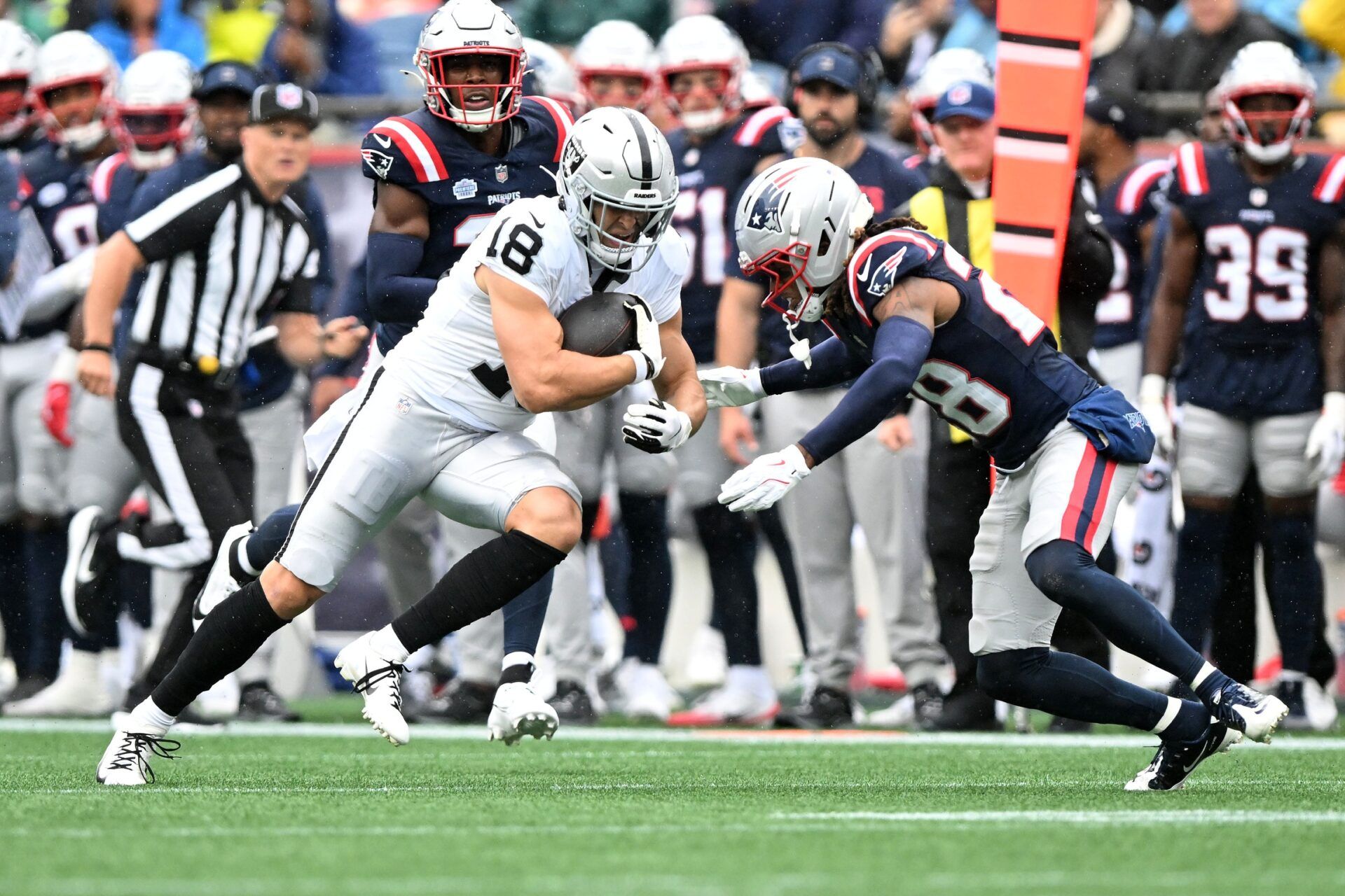 Las Vegas Raiders wide receiver Jack Bech (18) makes a catch against New England Patriots cornerback Alex Austin (28) during the first half at Gillette Stadium.