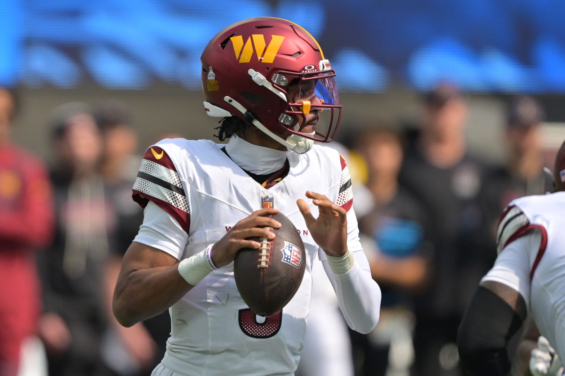 Washington Commanders quarterback Jayden Daniels (5) looks to throw against the Los Angeles Chargers in the first half at SoFi Stadium.