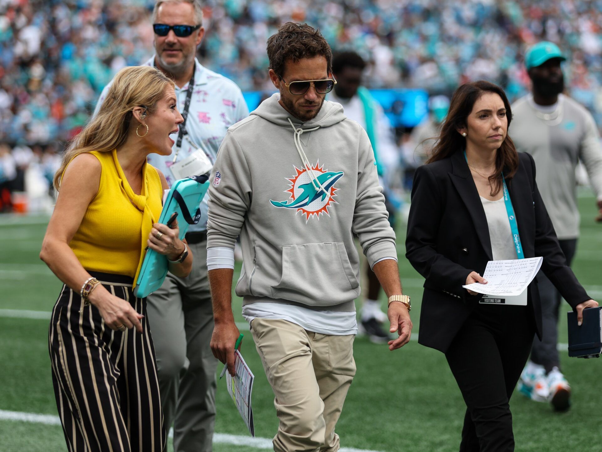 Miami Dolphins head coach Mike McDaniel talks with a reporter at the end of the first half of the Carolina Panthers and Miami Dolphins game at Bank of America Stadium.