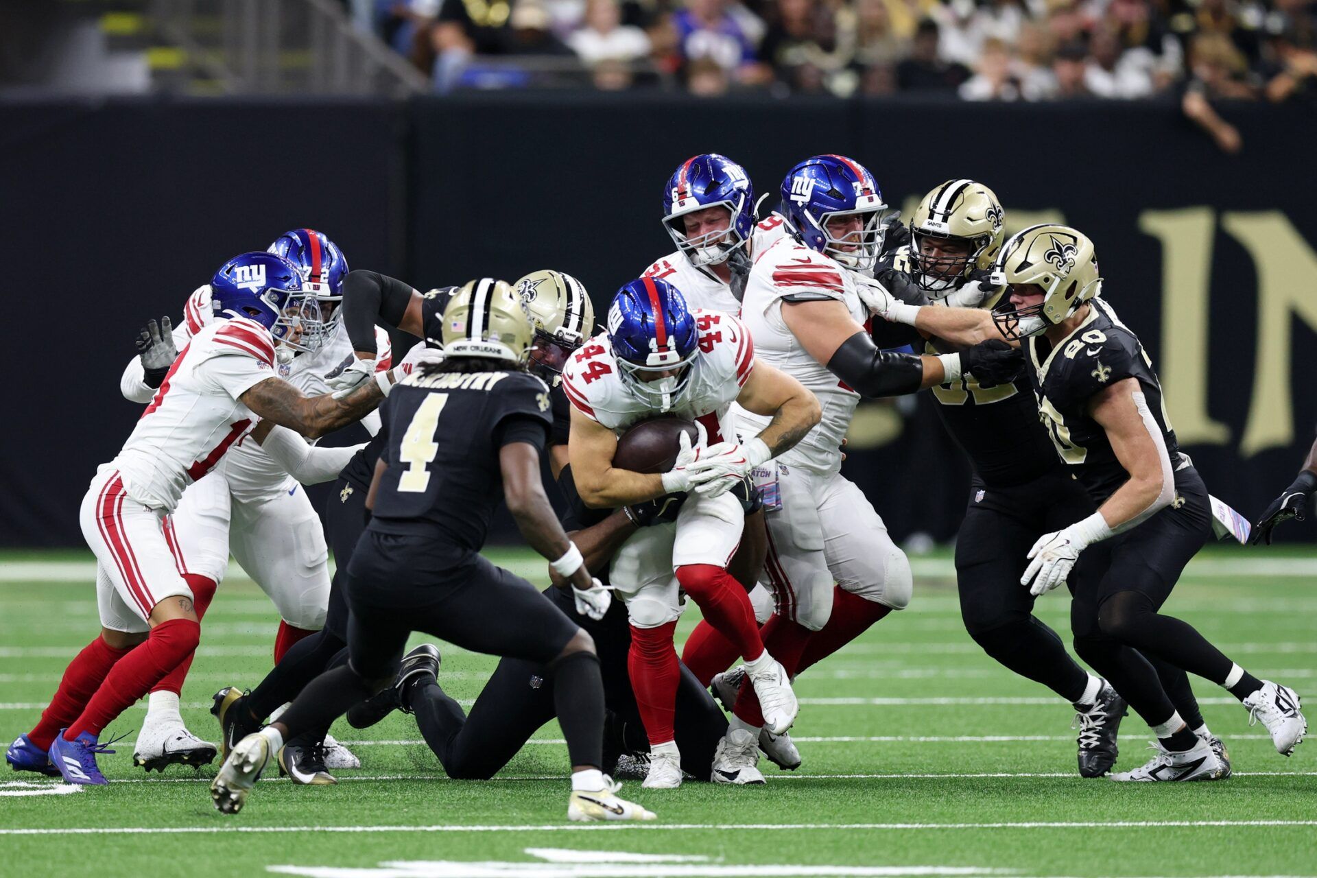New York Giants running back Cam Skattebo (44) runs with the ball against the New Orleans Saints during the first half at Caesars Superdome.