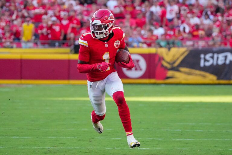Kansas City Chiefs wide receiver Xavier Worthy (1) runs the ball against the Baltimore Ravens during the game at GEHA Field at Arrowhead Stadium.