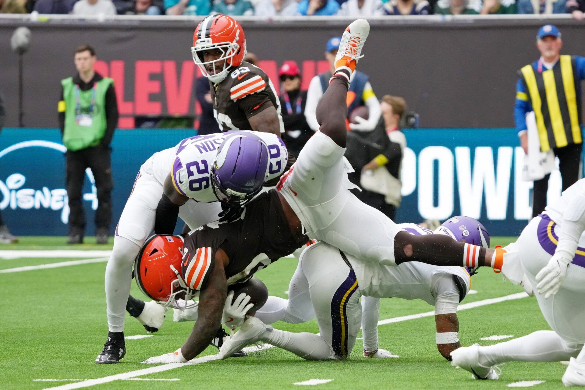 Cleveland Browns running back Quinshon Judkins (10) falls while defended by Minnesota Vikings safety Theo Jackson (26) during the third quarter of an NFL International Series game at Tottenham Hotspur Stadium.