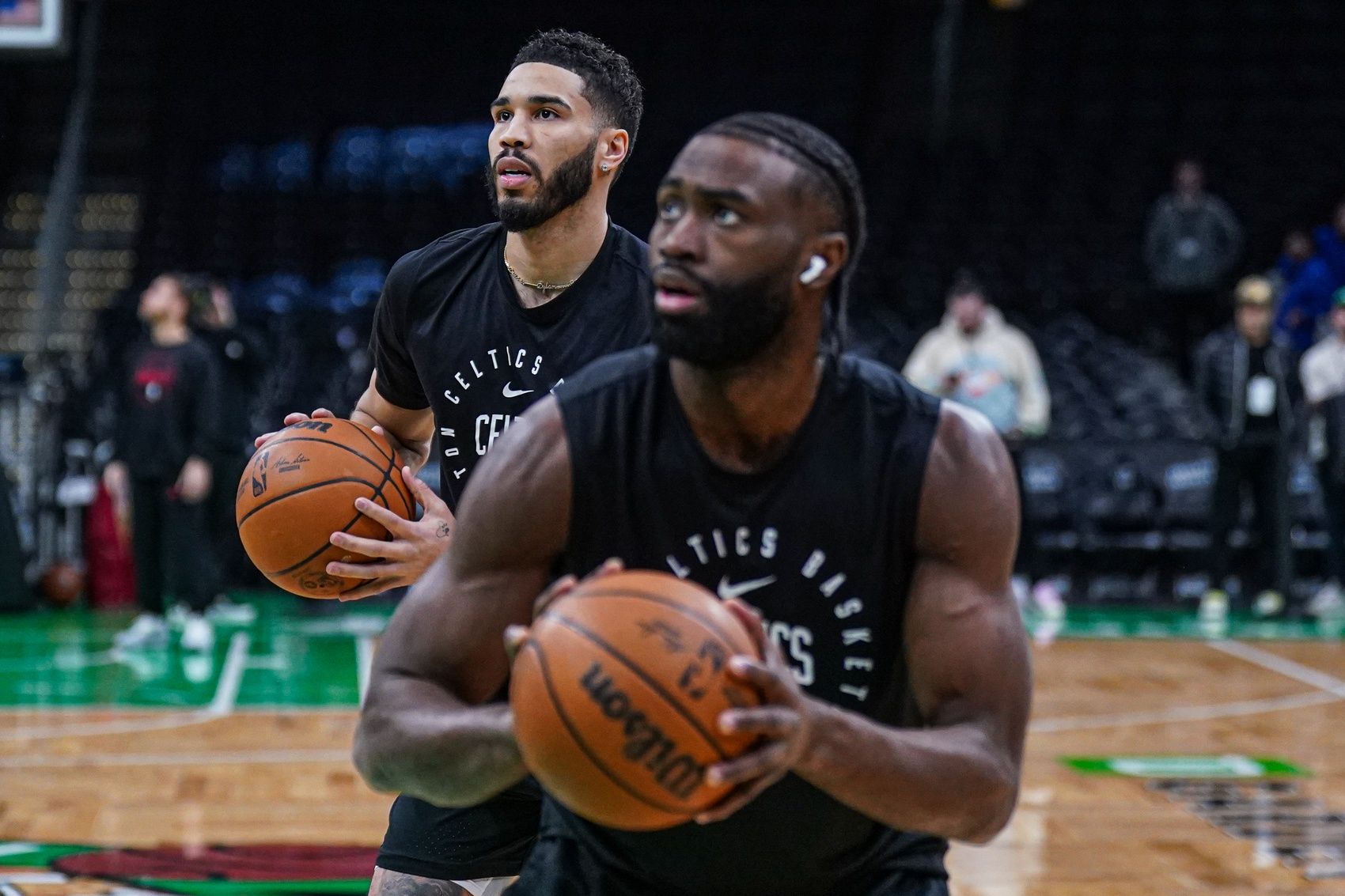 Boston Celtics forward Jayson Tatum (0) and guard Jaylen Brown (7) warm up before the start of the game against the Houston Rockets at TD Garden.