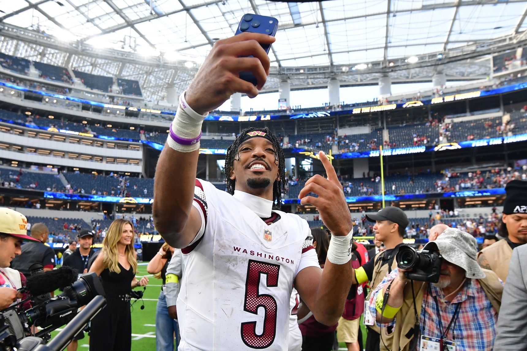 Washington Commanders quarterback Jayden Daniels (5) celebrates after the game against the Los Angeles Chargers at SoFi Stadium.