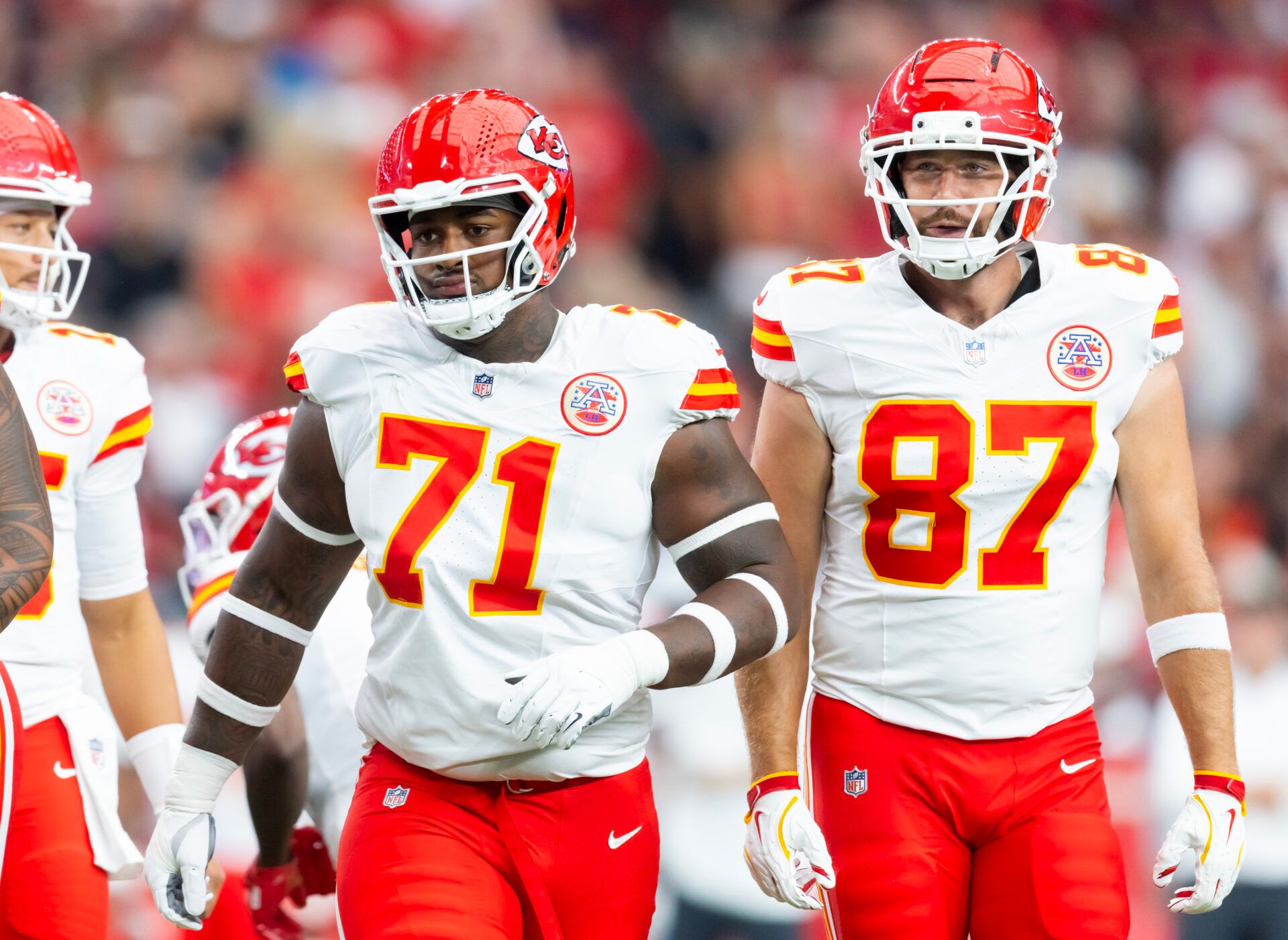 Kansas City Chiefs offensive tackle Josh Simmons (71) and tight end Travis Kelce (87) against the Arizona Cardinals during a preseason NFL game at State Farm Stadium.