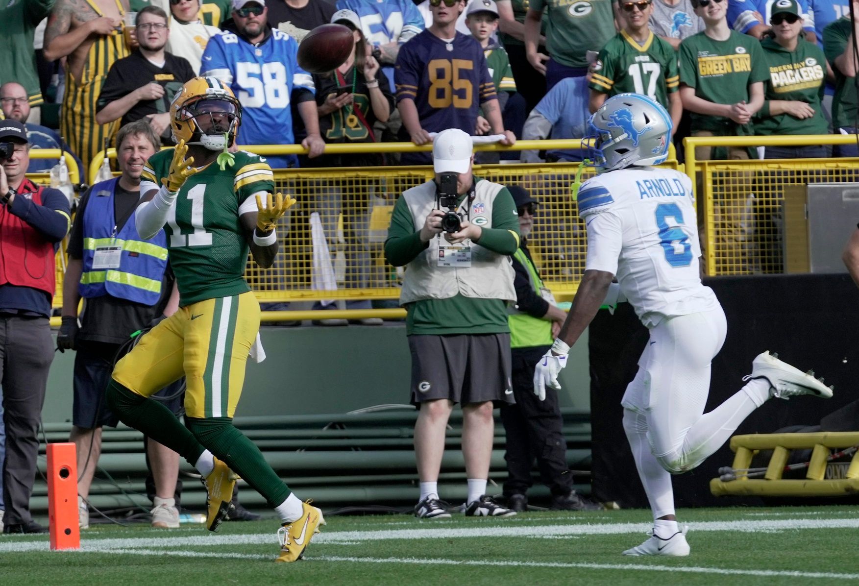 Green Bay Packers wide receiver Jayden Reed (11) catches a touchdown pass while being covered by Detroit Lions cornerback Terrion Arnold (6) during the second quarter of their game Sunday, September 7, 2025 at Lambeau Field in Green Bay, Wisconsin.