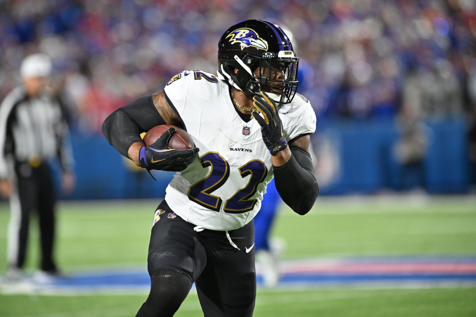 Baltimore Ravens running back Derrick Henry (22) carries the ball against the Buffalo Bills in the first quarter at Highmark Stadium.
