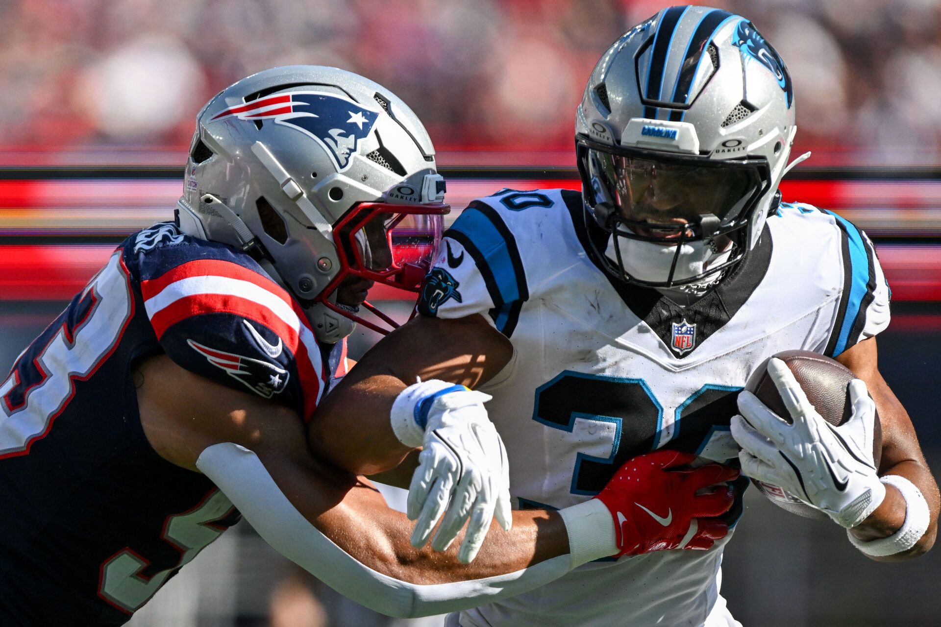 New England Patriots linebacker Christian Elliss (53) tackles Carolina Panthers running back Chuba Hubbard (30) during the second half at Gillette Stadium.