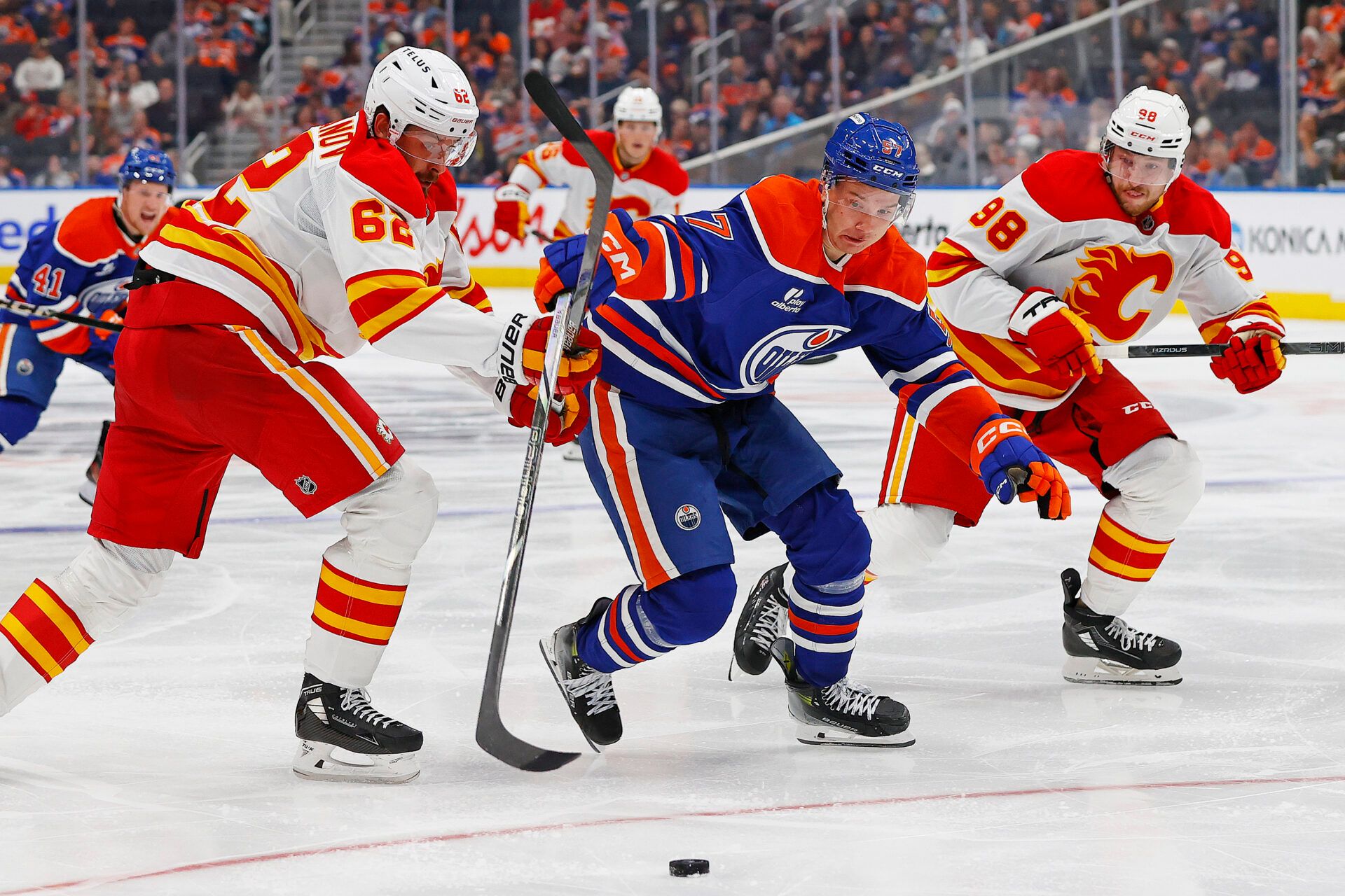 Edmonton Oilers forward Viljami Marjala (57) carries the puck past Calgary Flames defensemen Daniil Miromanov (62) during the third period Edmonton Oilers at Rogers Place.