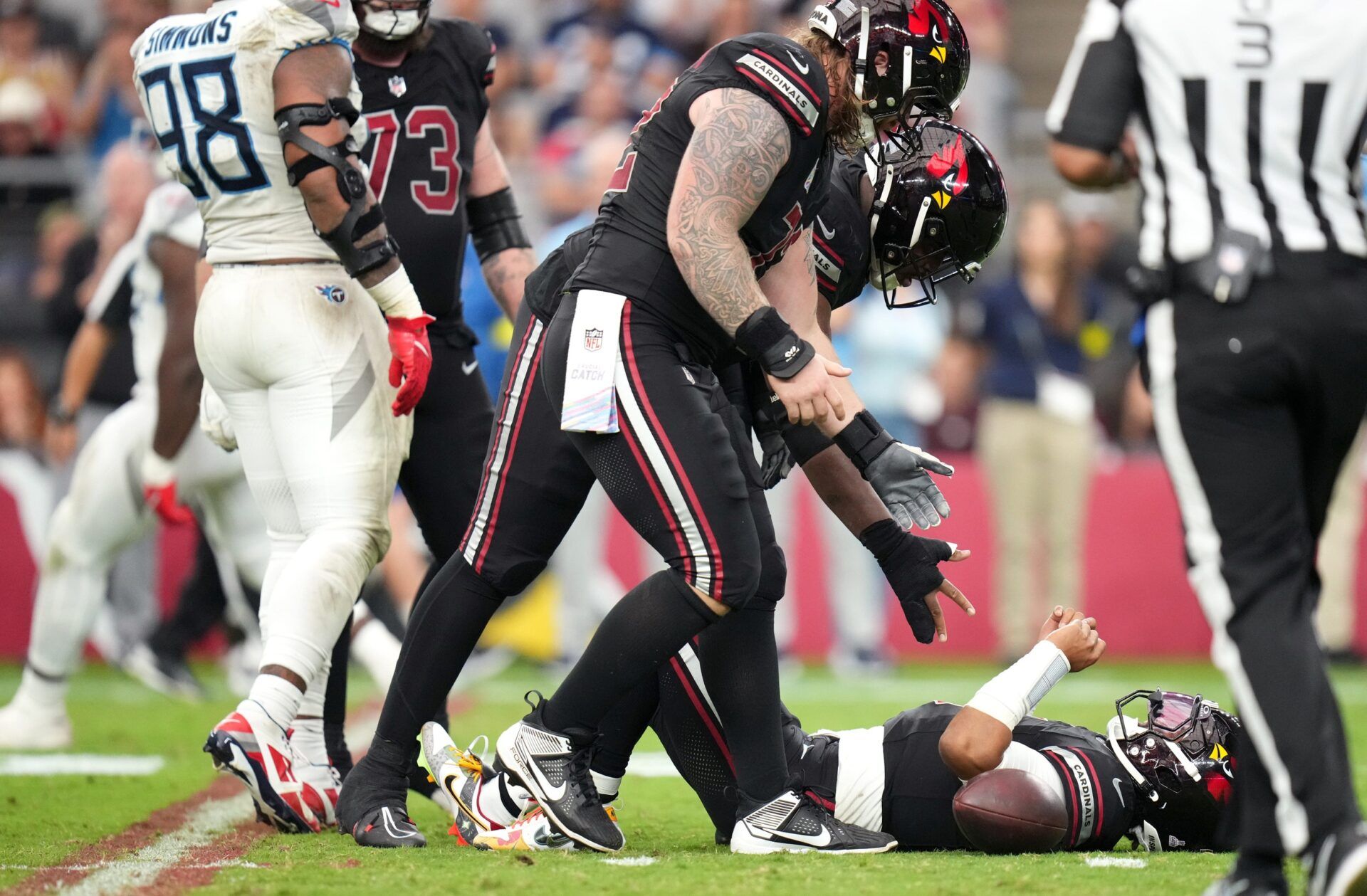 Arizona Cardinals quarterback Kyler Murray (1) is helped off the ground after being sacked by the Tennessee Titans at State Farm Stadium in Glendale on Oct. 5, 2025.