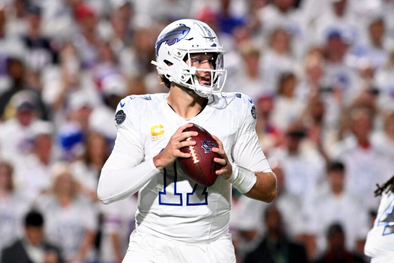 Buffalo Bills quarterback Josh Allen (17) drops back to pass against the New England Patriots during the first half at Highmark Stadium.